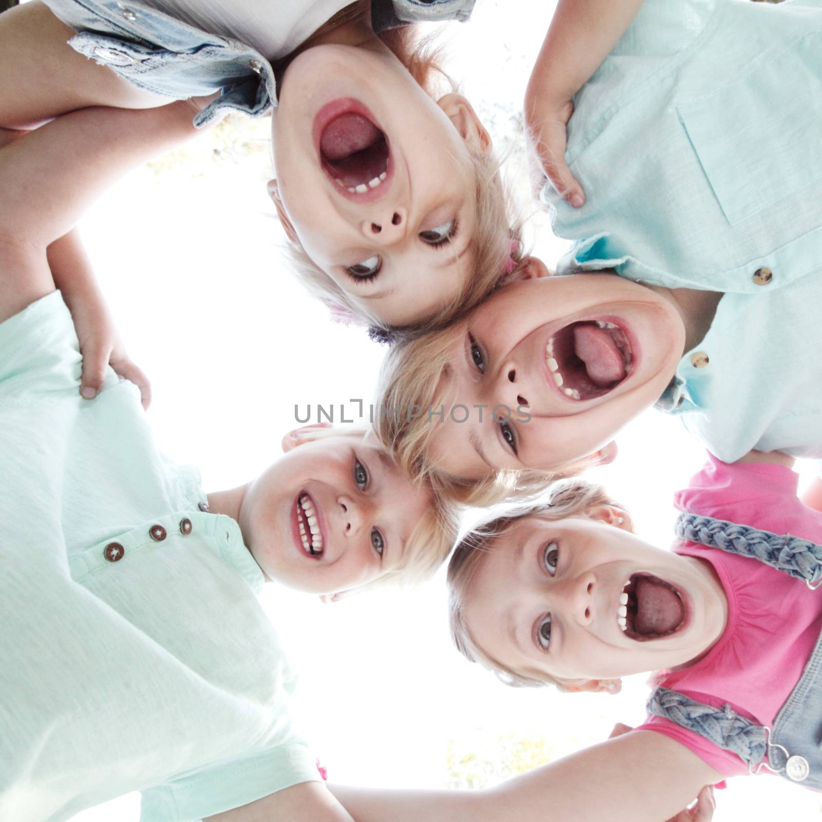 Group of smiling children looking down into camera