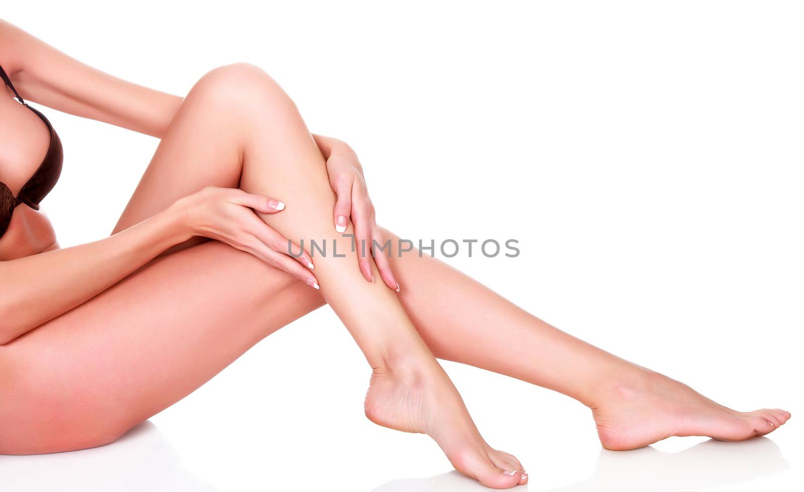 Woman's legs and hands, isolated on white background by Nobilior