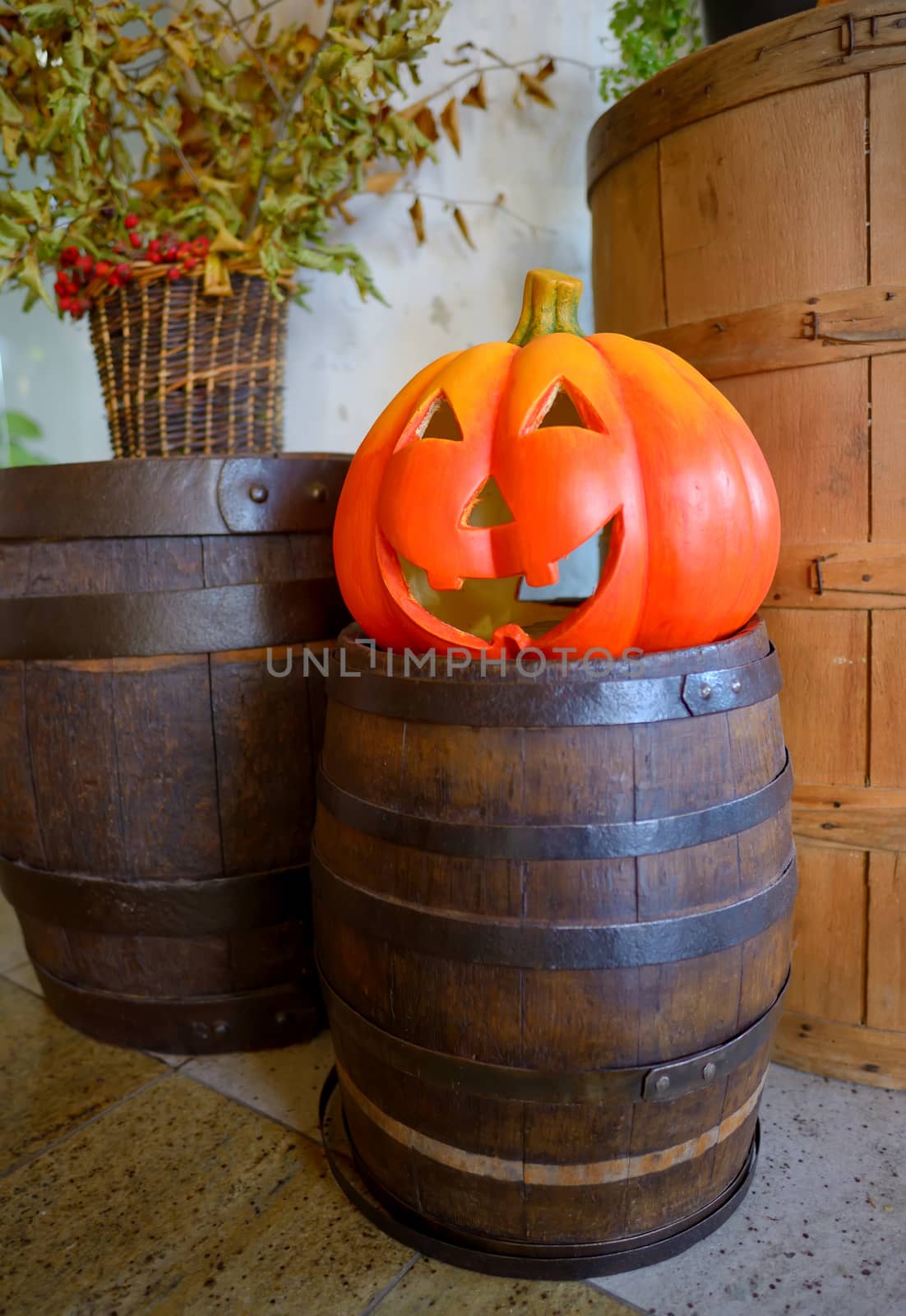 Halloween pumpkin head jack lantern on wooden barrel