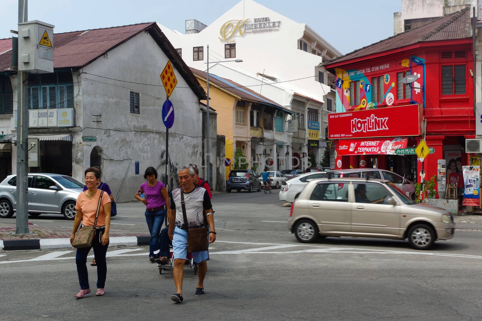 Georgetown, Penang, Malaysia - April 18, 2016 : few local people and cars walking driving around the street