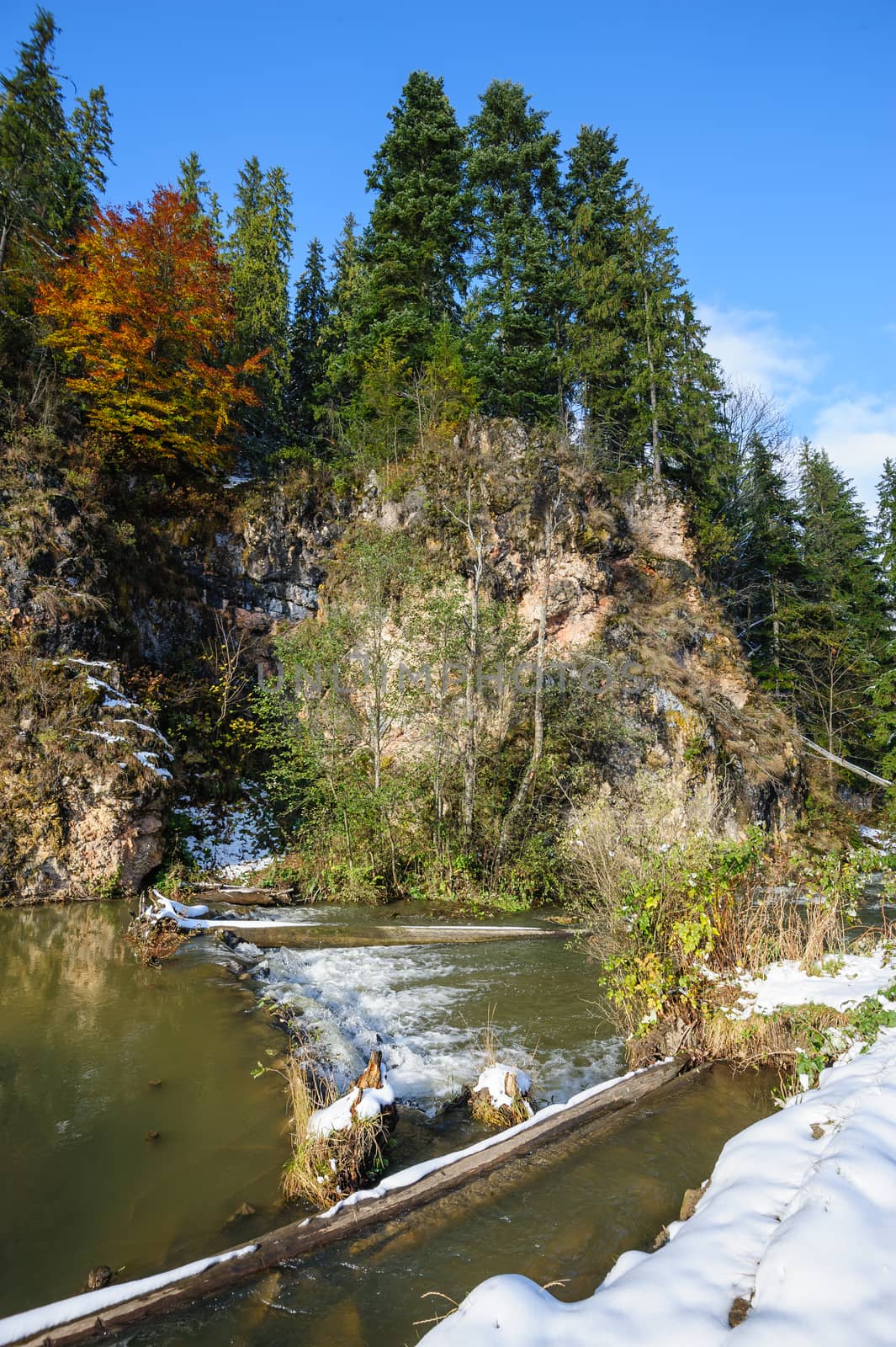 Small rapids at Lacul Rosu, the Red Lake or Killer Lake, Eastern Carpathians, Transylvania, Romania at autumn