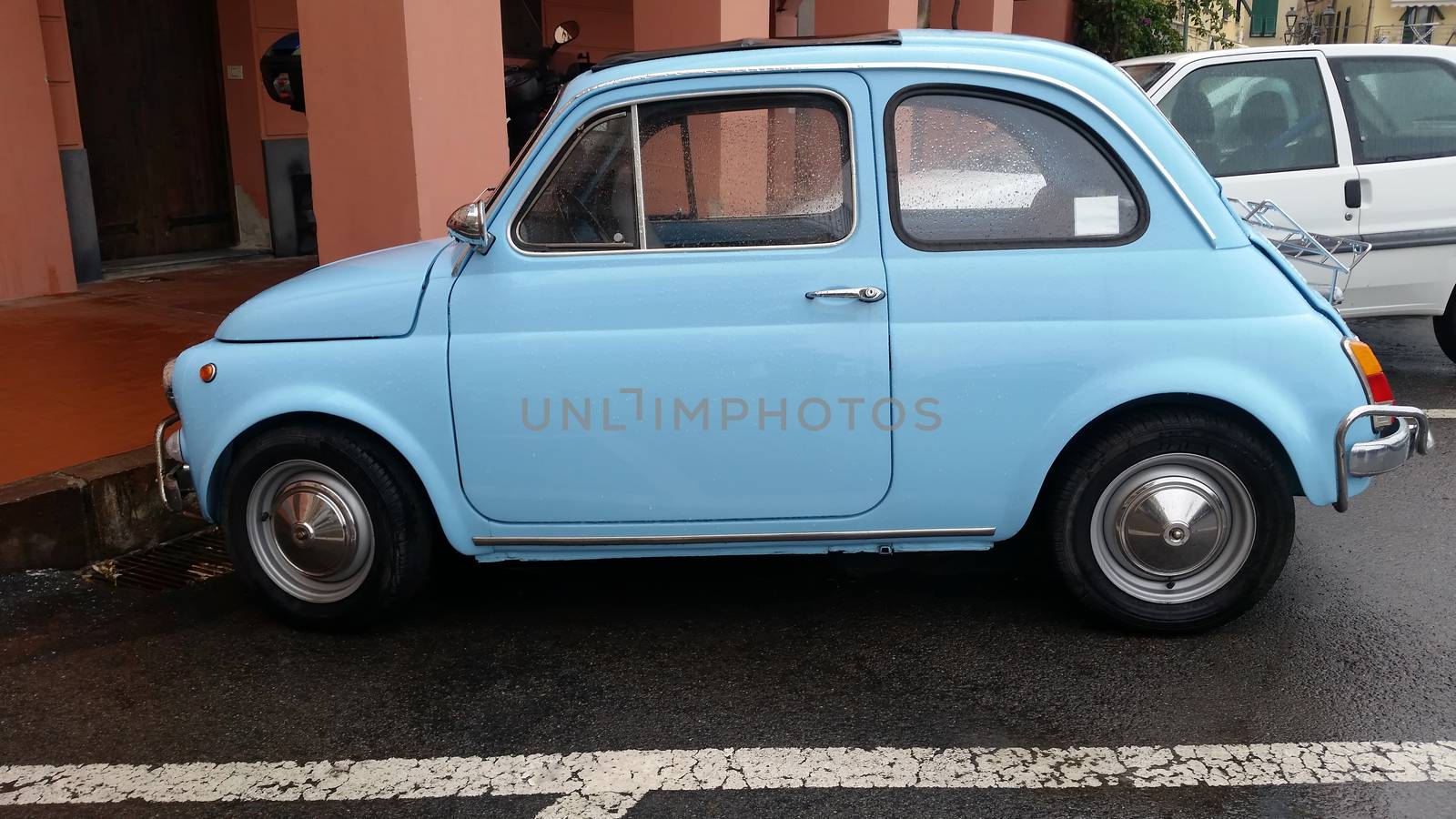 Ventimiglia, Italy - October 23, 2016: Small Italian Car Fiat 500 Parked on the Street of Ventimiglia. Blue Fiat 500 L
