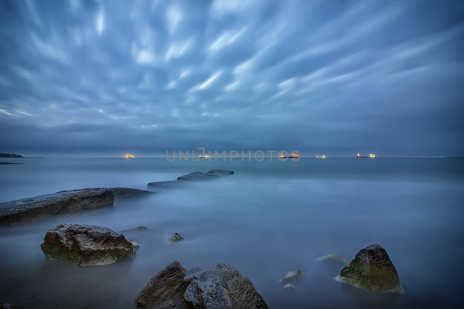 stunning long exposure seascape with on rocks on the beach