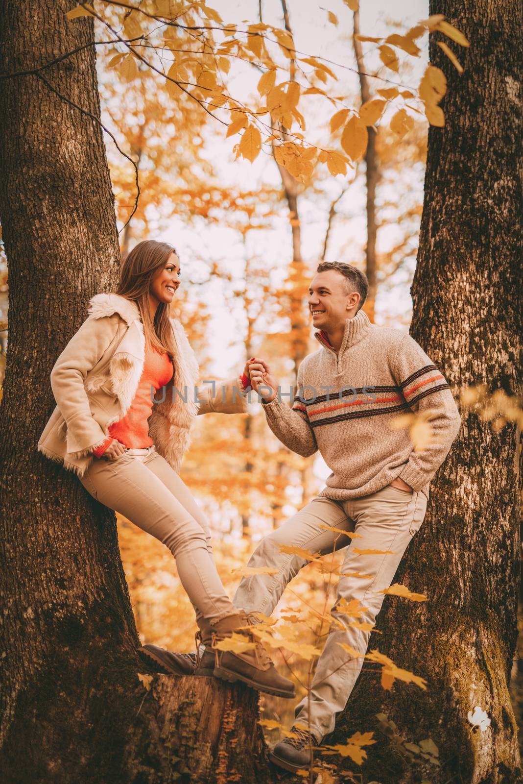 Beautiful lovely couple enjoying in forest in autumn colors.