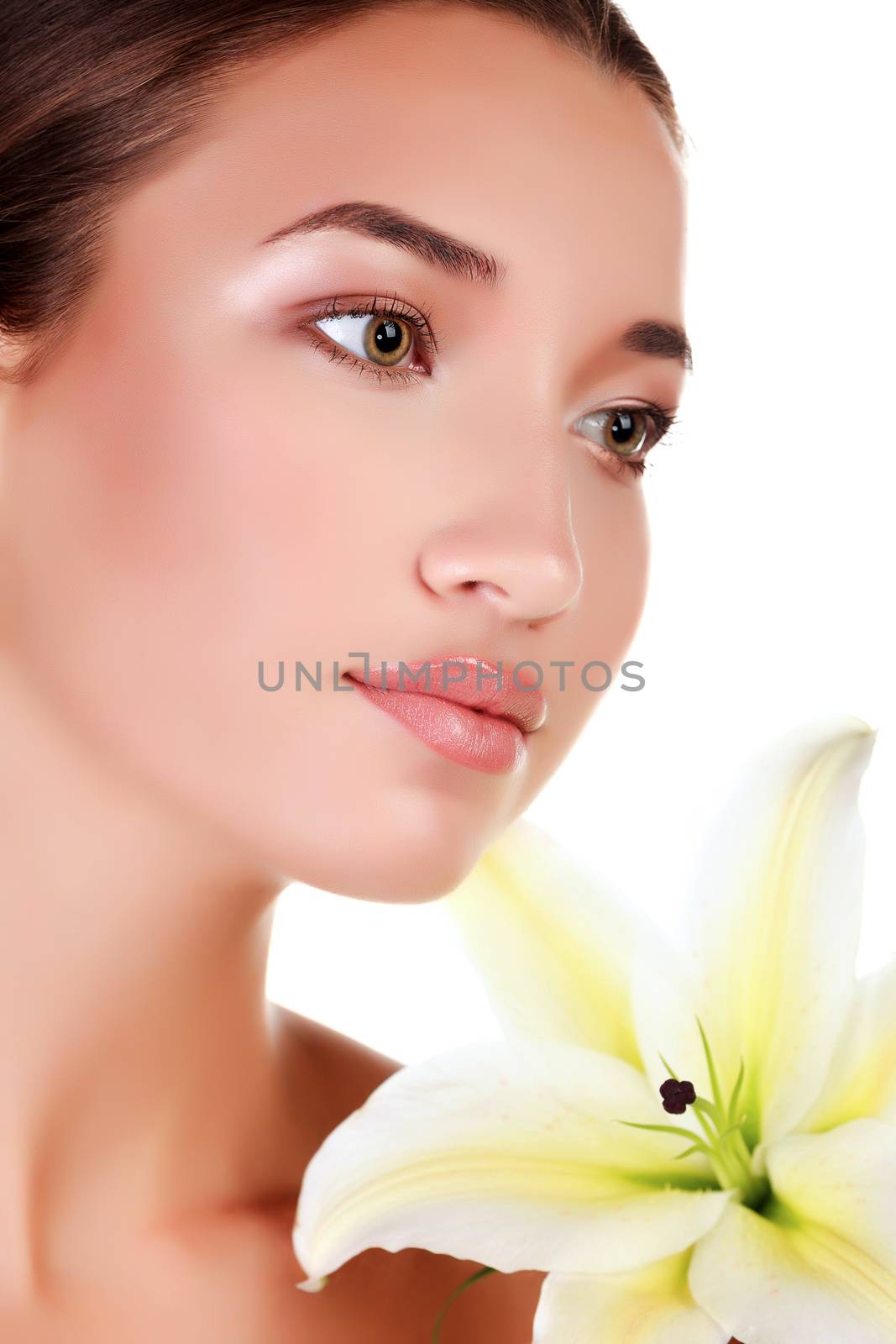 Face of a beautiful girl with a fresh flower lily, isolated on white background