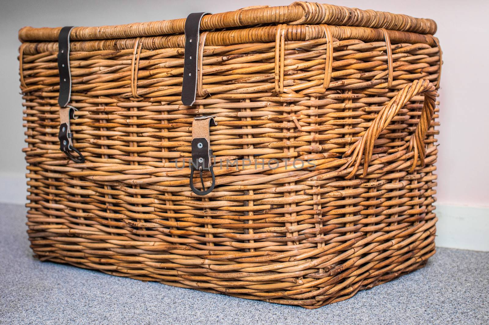 Wicker basket on the light background in the room