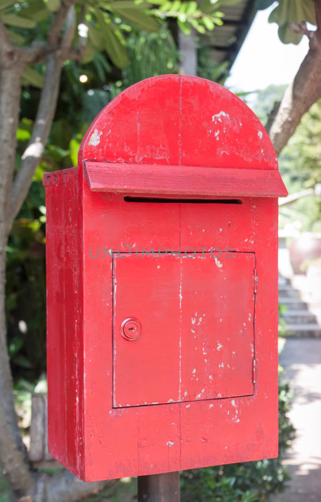 Old wooden red post box by punsayaporn