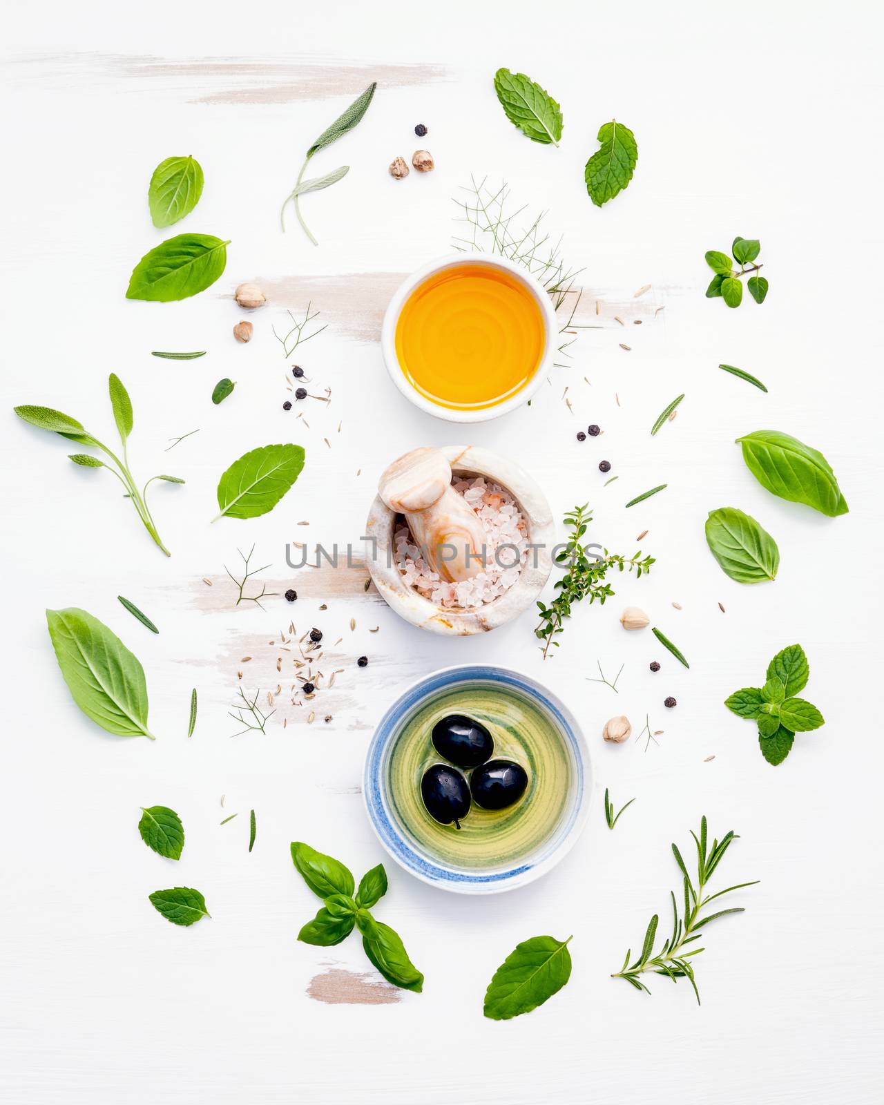 Different sorts of cooking oils. Olive oil flavored ,spice oils and sesame oil with herbs rosemary ,thyme,dill,sage ,peppermint ,oregano , sweet basil and parsley setup with shabby wooden background .