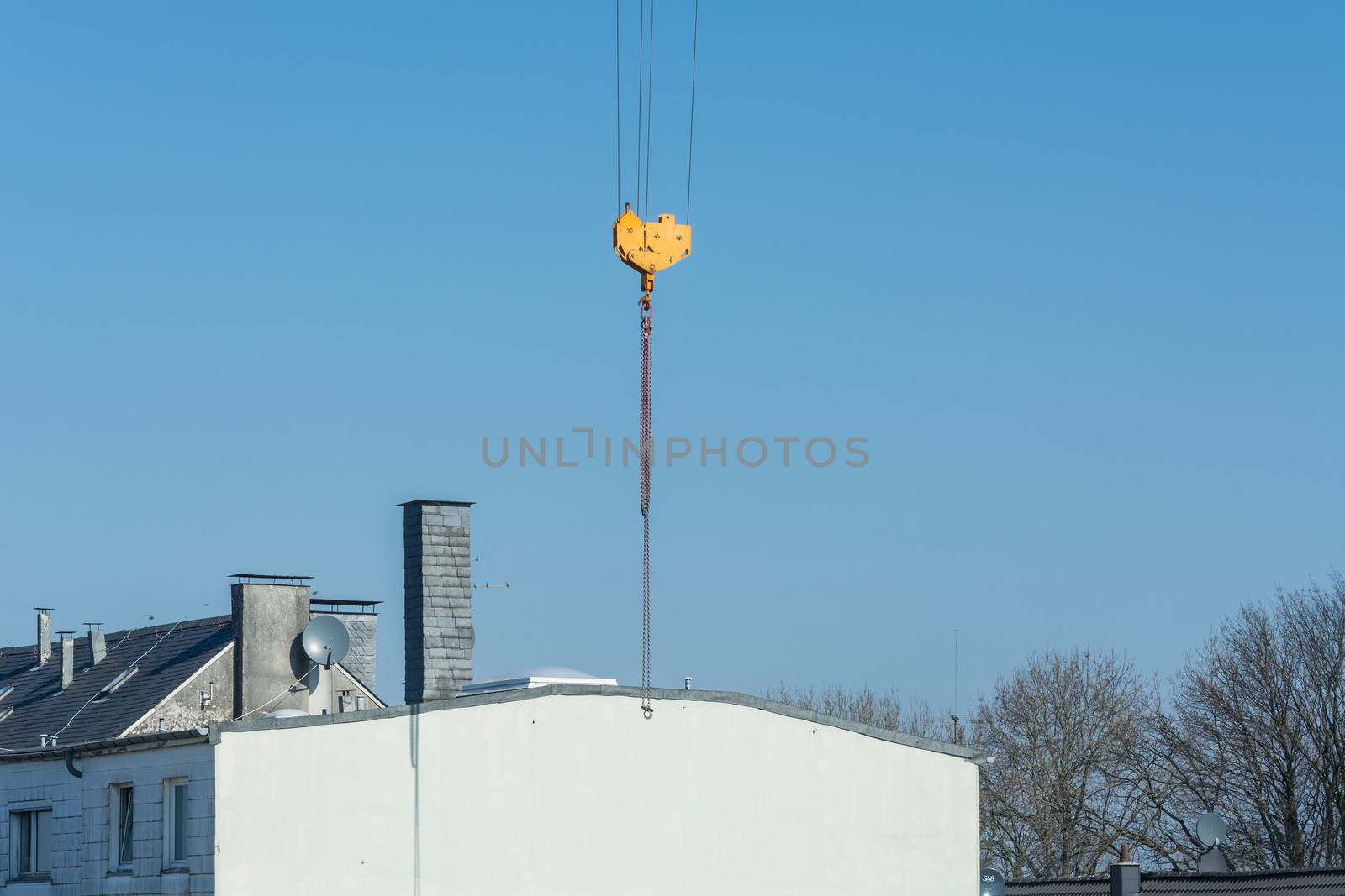 Construction crane against blue sky photographed, space for labeling.