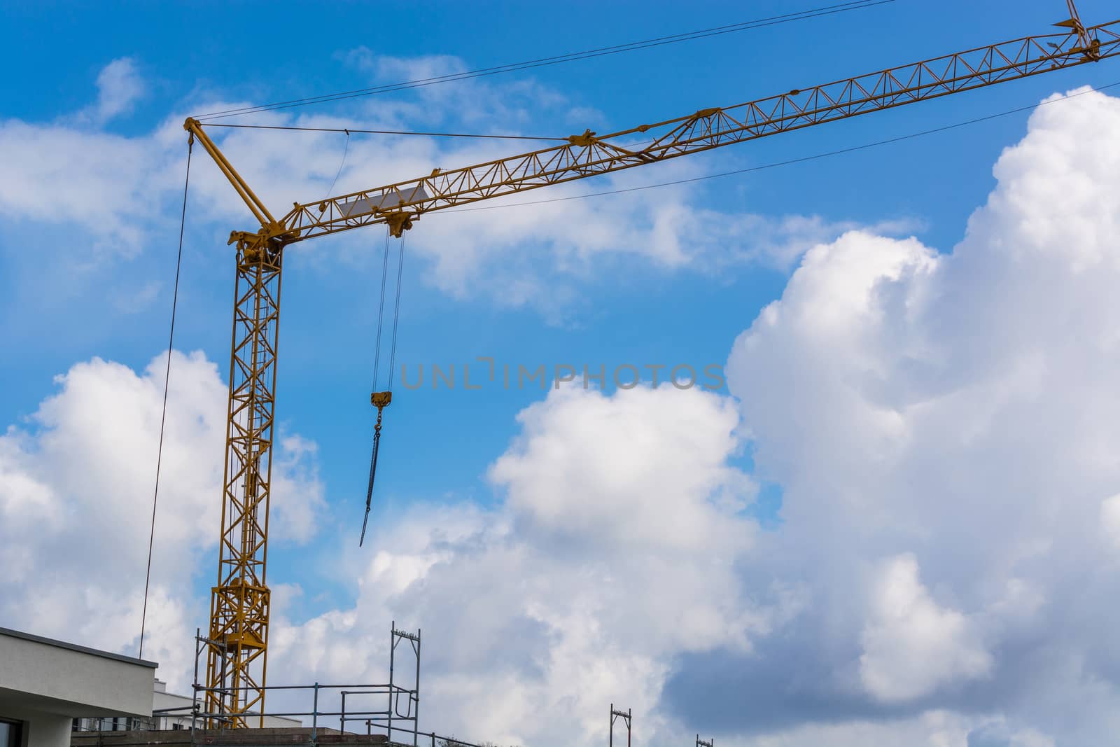 Construction crane against blue sky photographed by JFsPic