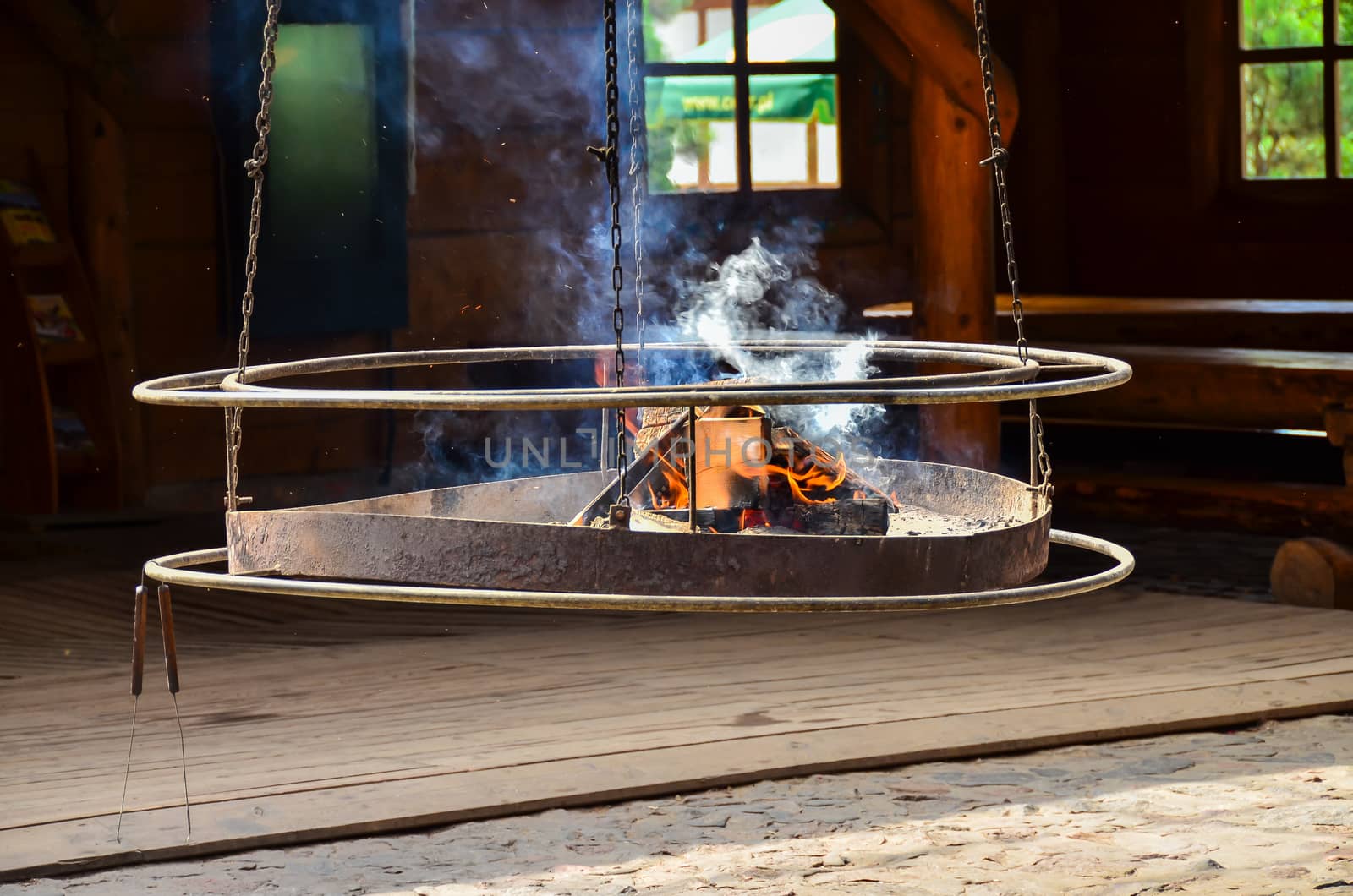 Image of a hanging grill with the fire ready for barbecue