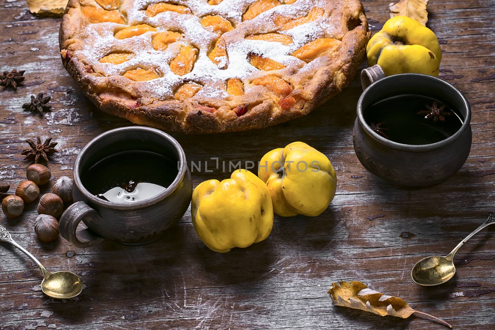 Autumn pie with slices of quince and warming cup of tea