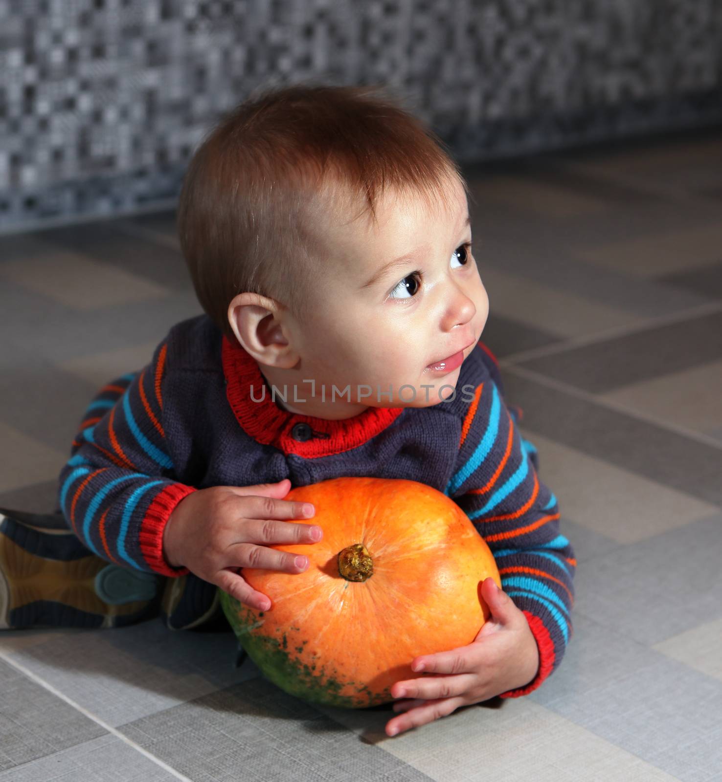 boy of eight months with pumpkin by ssuaphoto