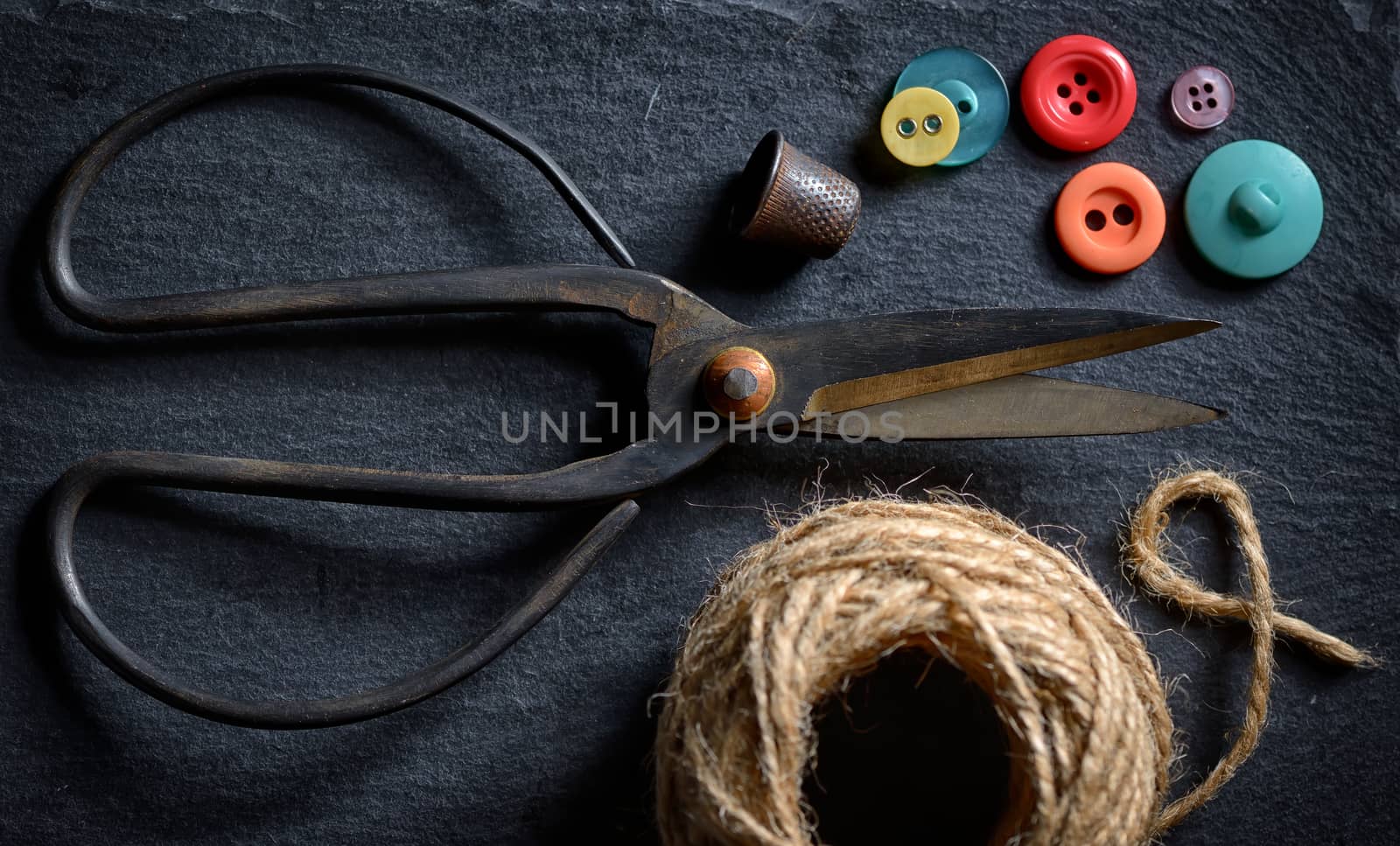 vintage scissors with a roll of twine and buttons