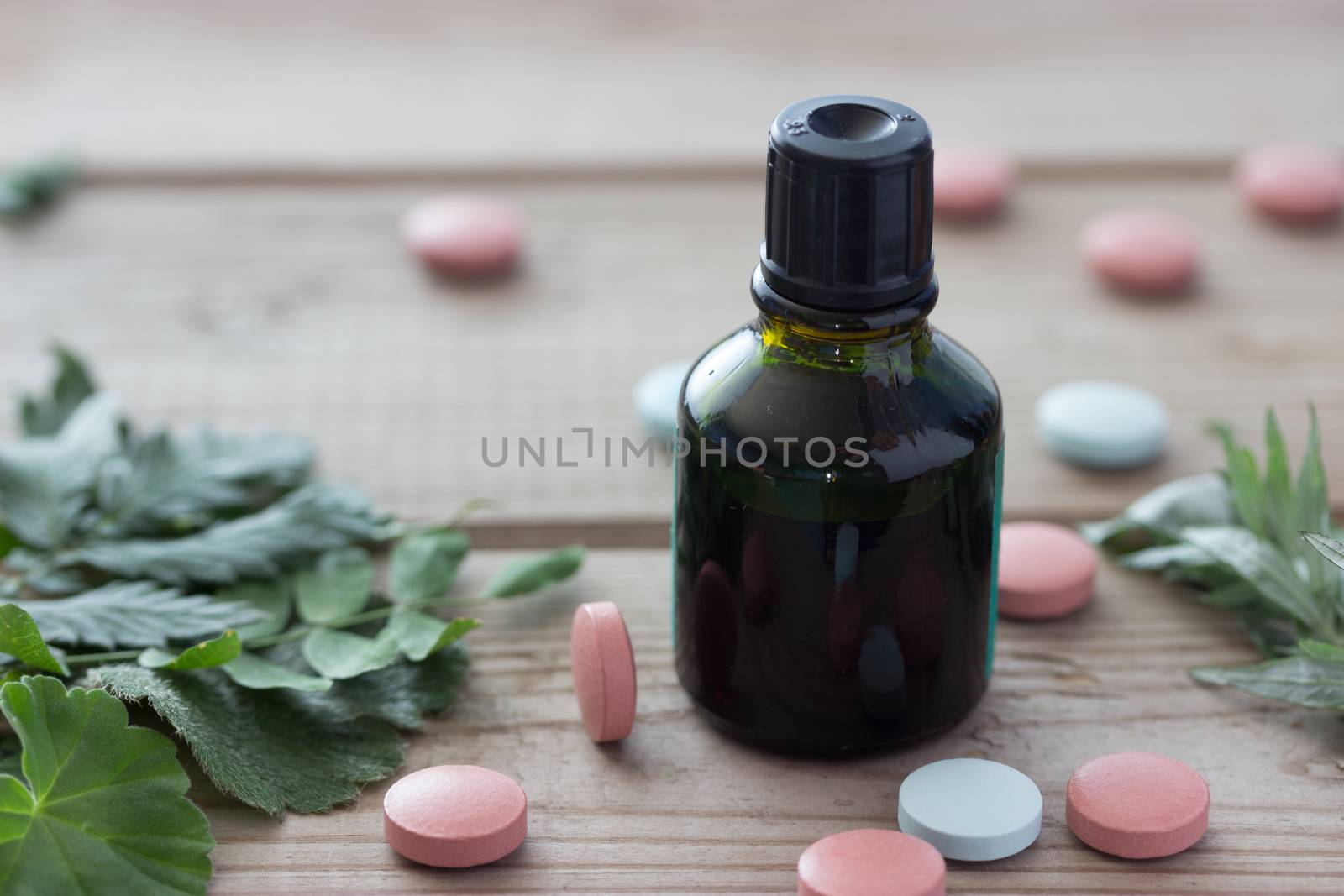 pill plant and bottle on wooden table,