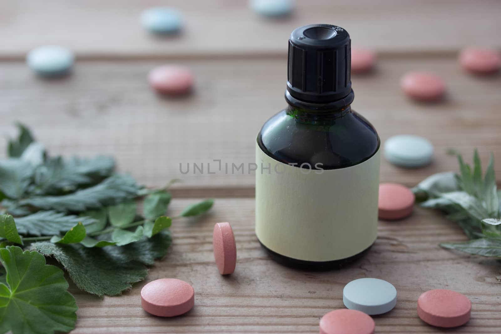 pill plant and bottle on wooden table,