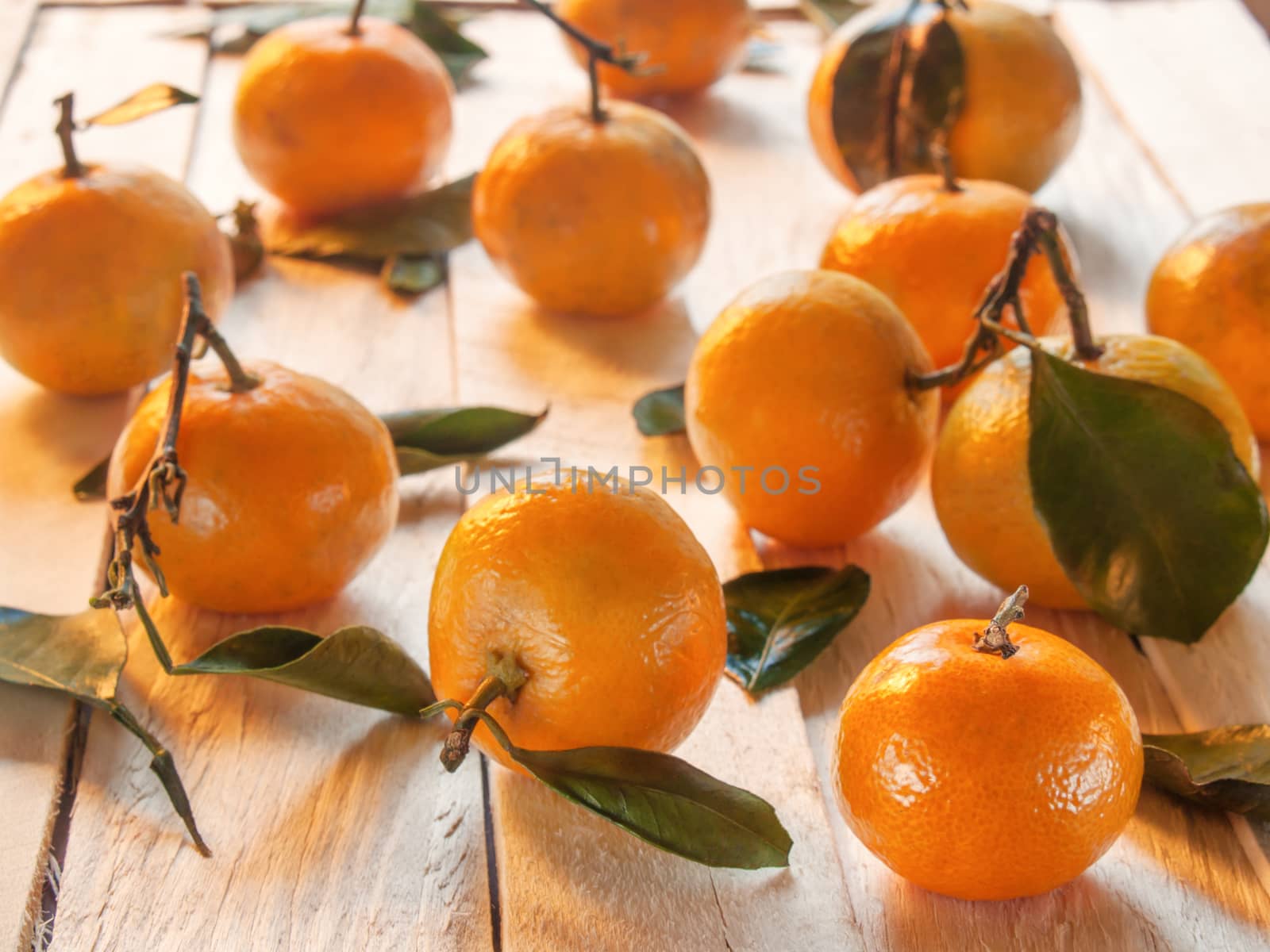 Beautiful, juicy, sweet, orange tangerines lie on the wooden table