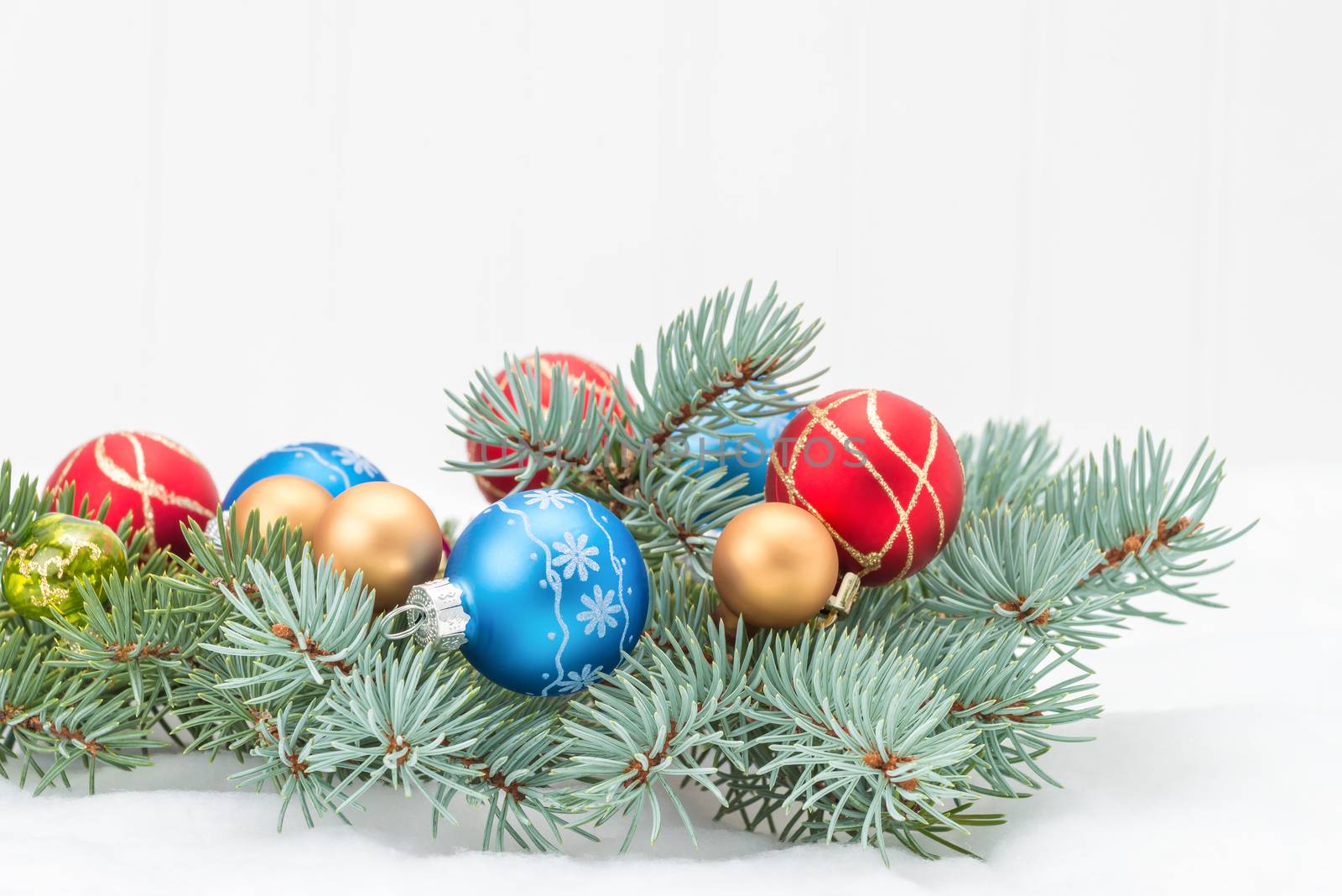 Spruce bough decorated with colorful glass ornaments.