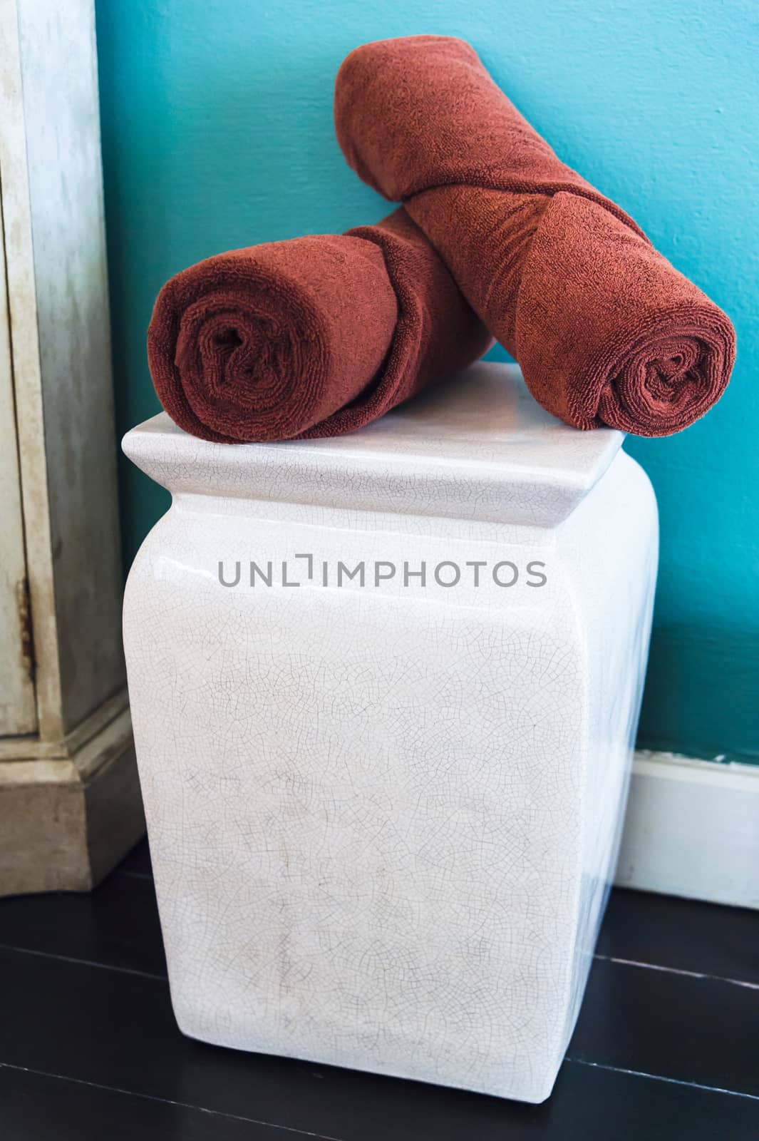 brown towels on white chair in room