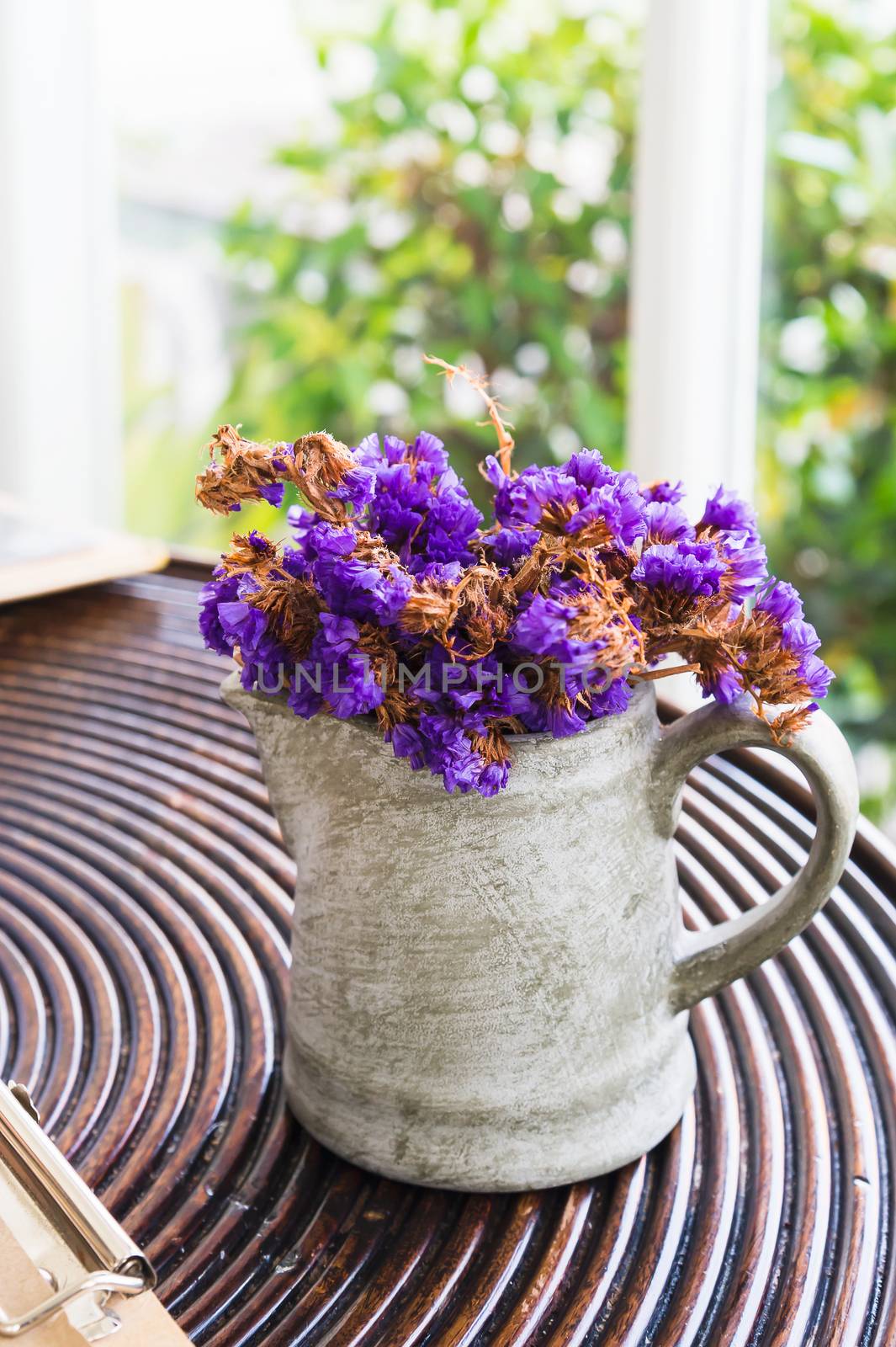 dried purple flower in pot on wooden table by luckyfim