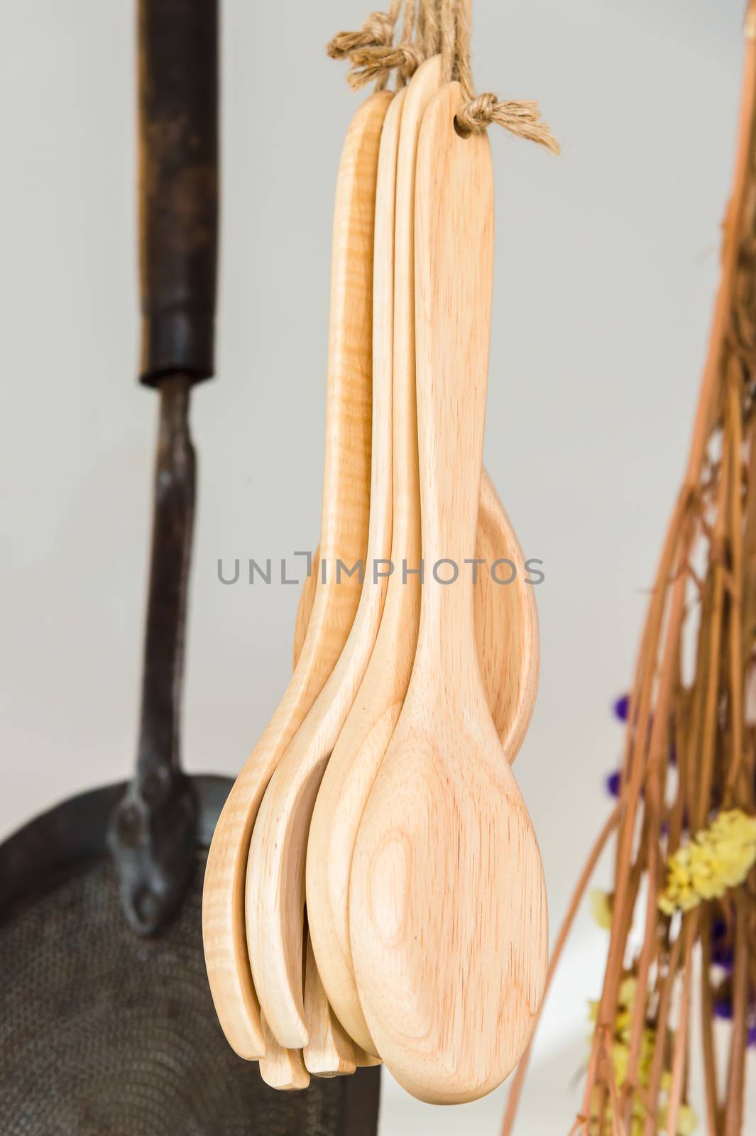 wooden spoons hanging with rope in kitchen