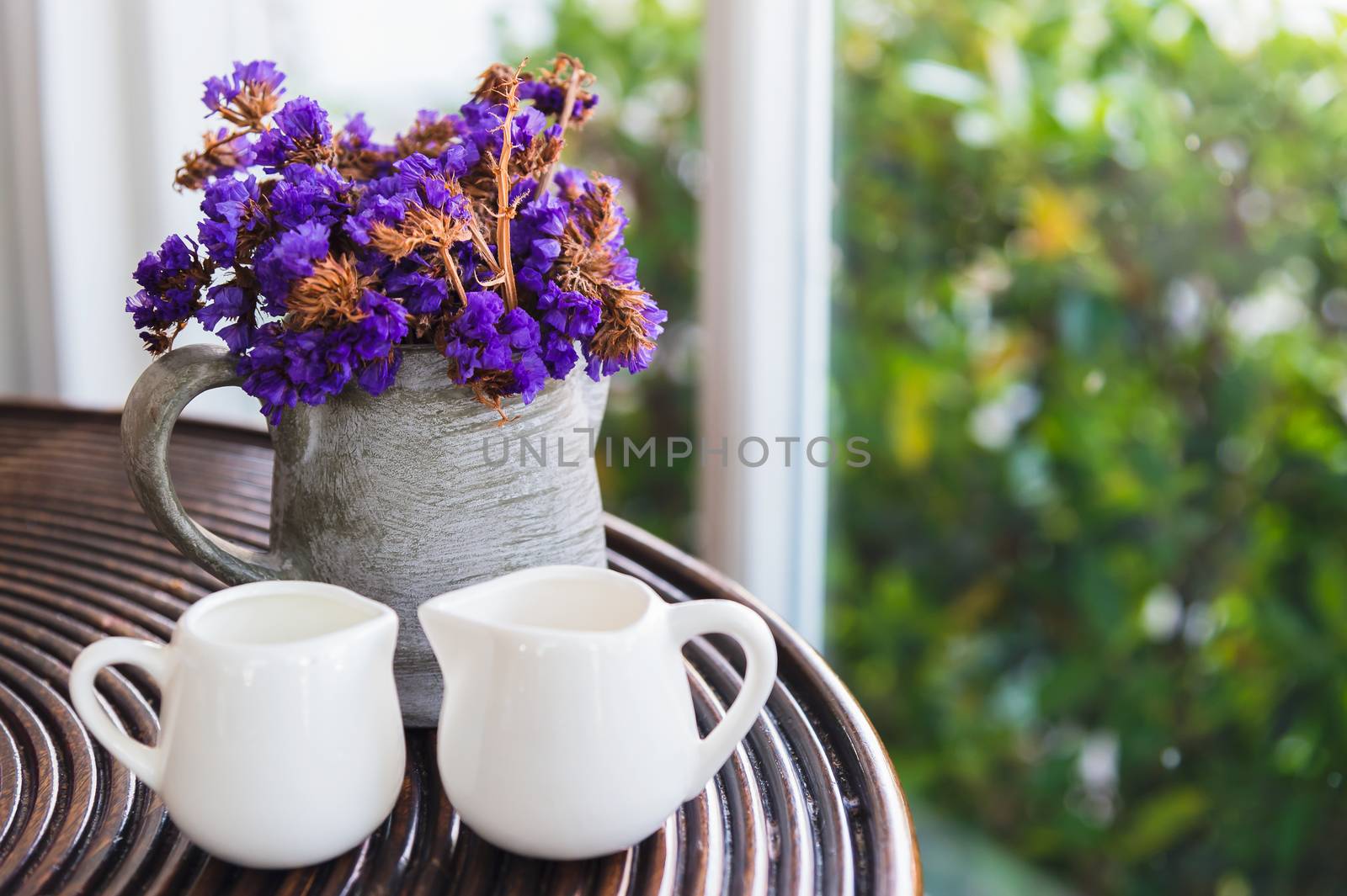 dried purple flower in pot on wooden table