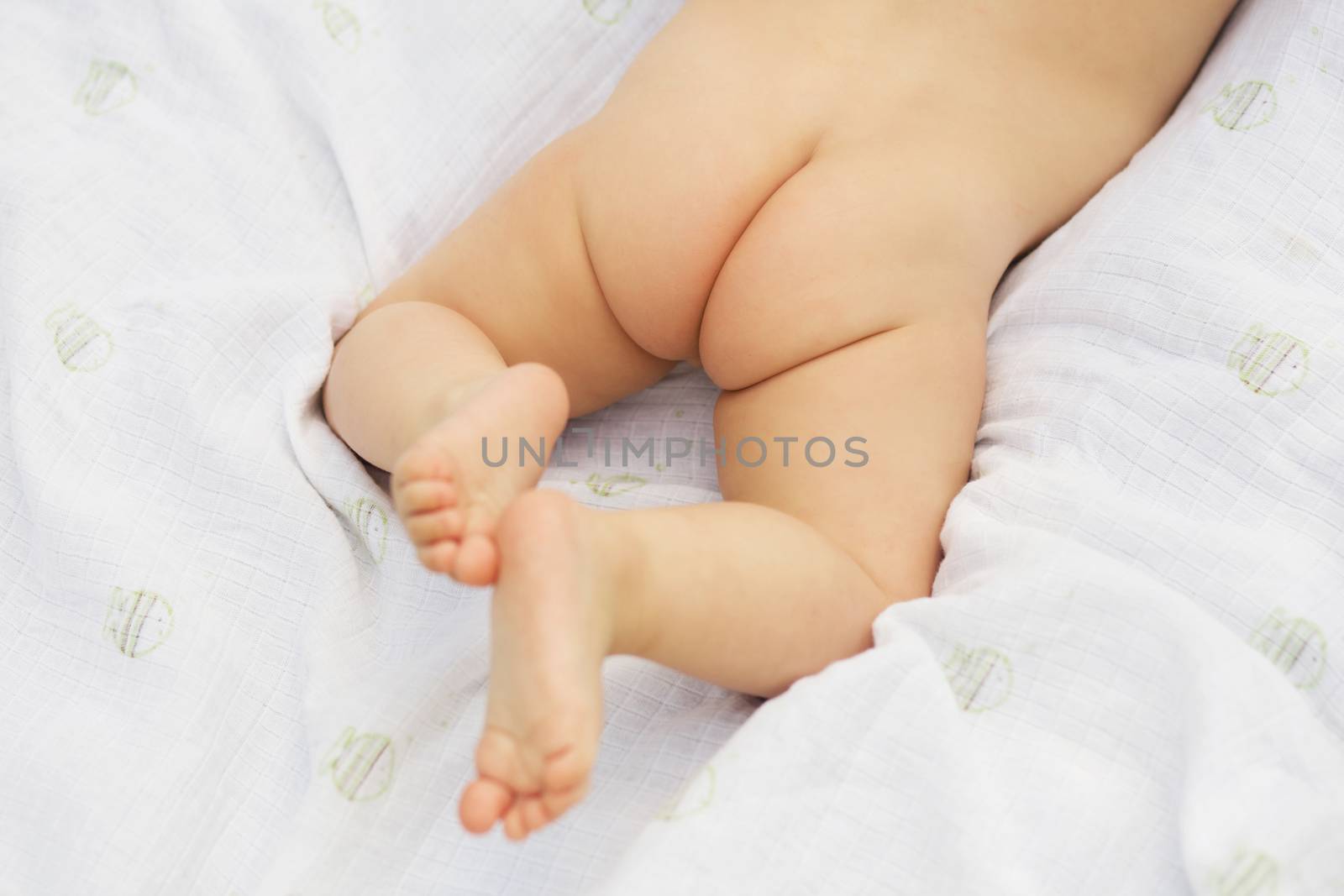 Naked baby's bottom and legs. Child take air baths