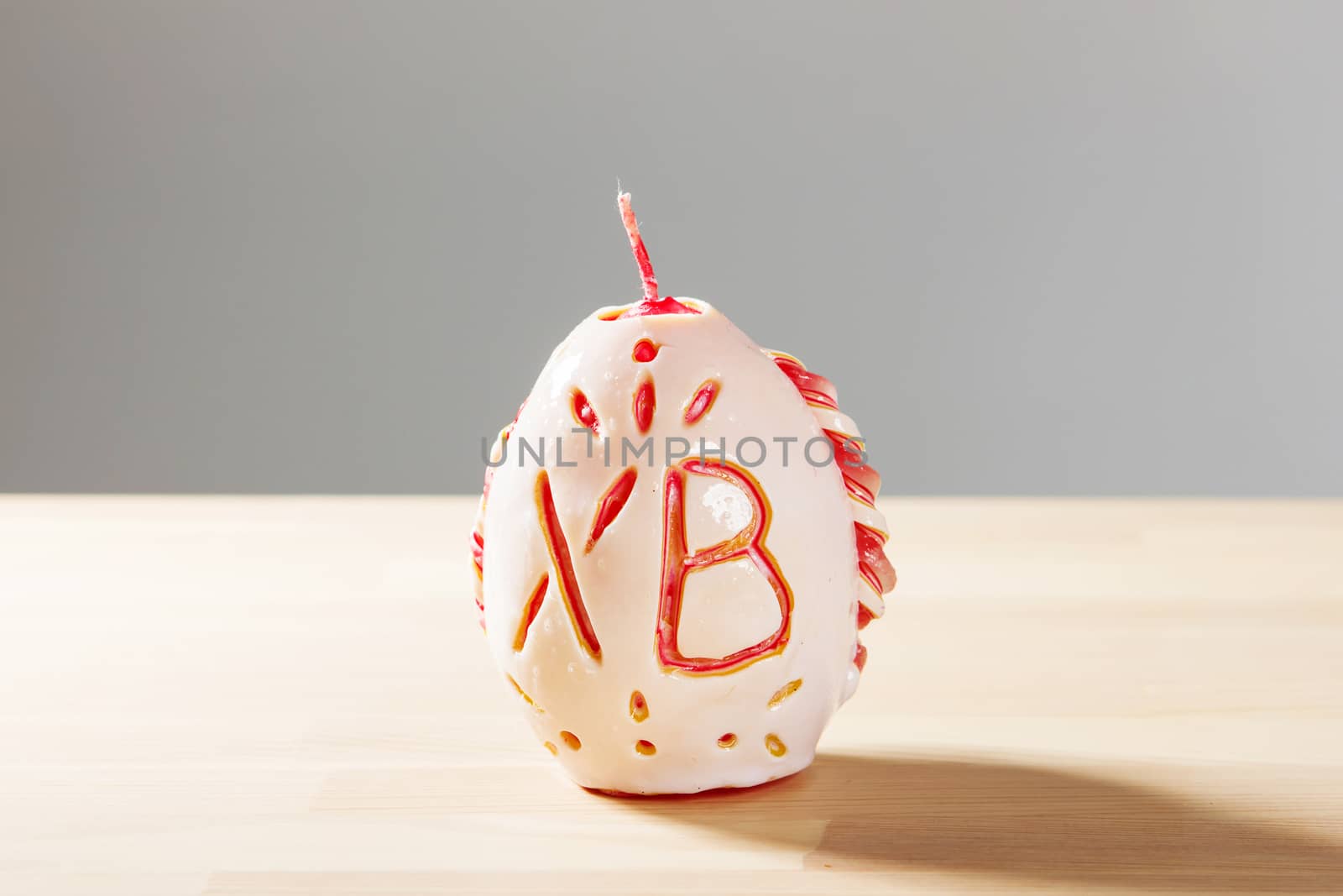 Carved colored candle isolated on white background