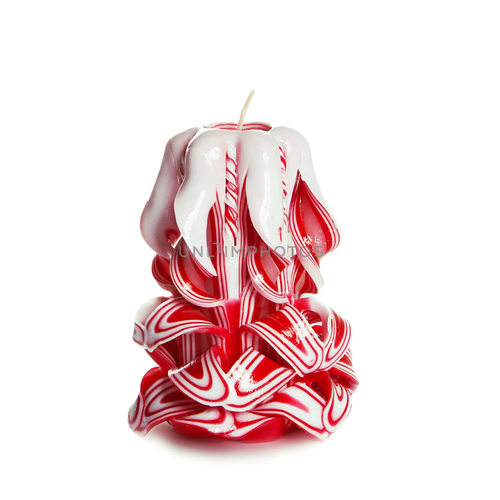 Carved colored candle isolated on white background