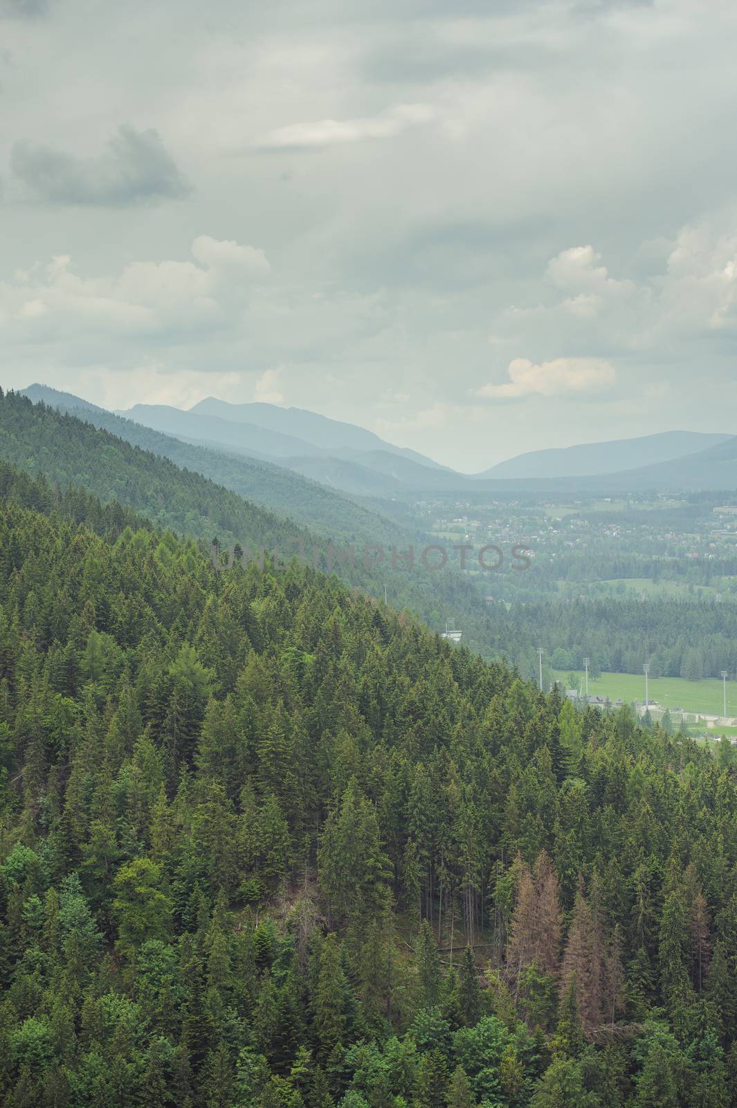 Mountains under mist in the morning and city in the valley. Tatra Mountain