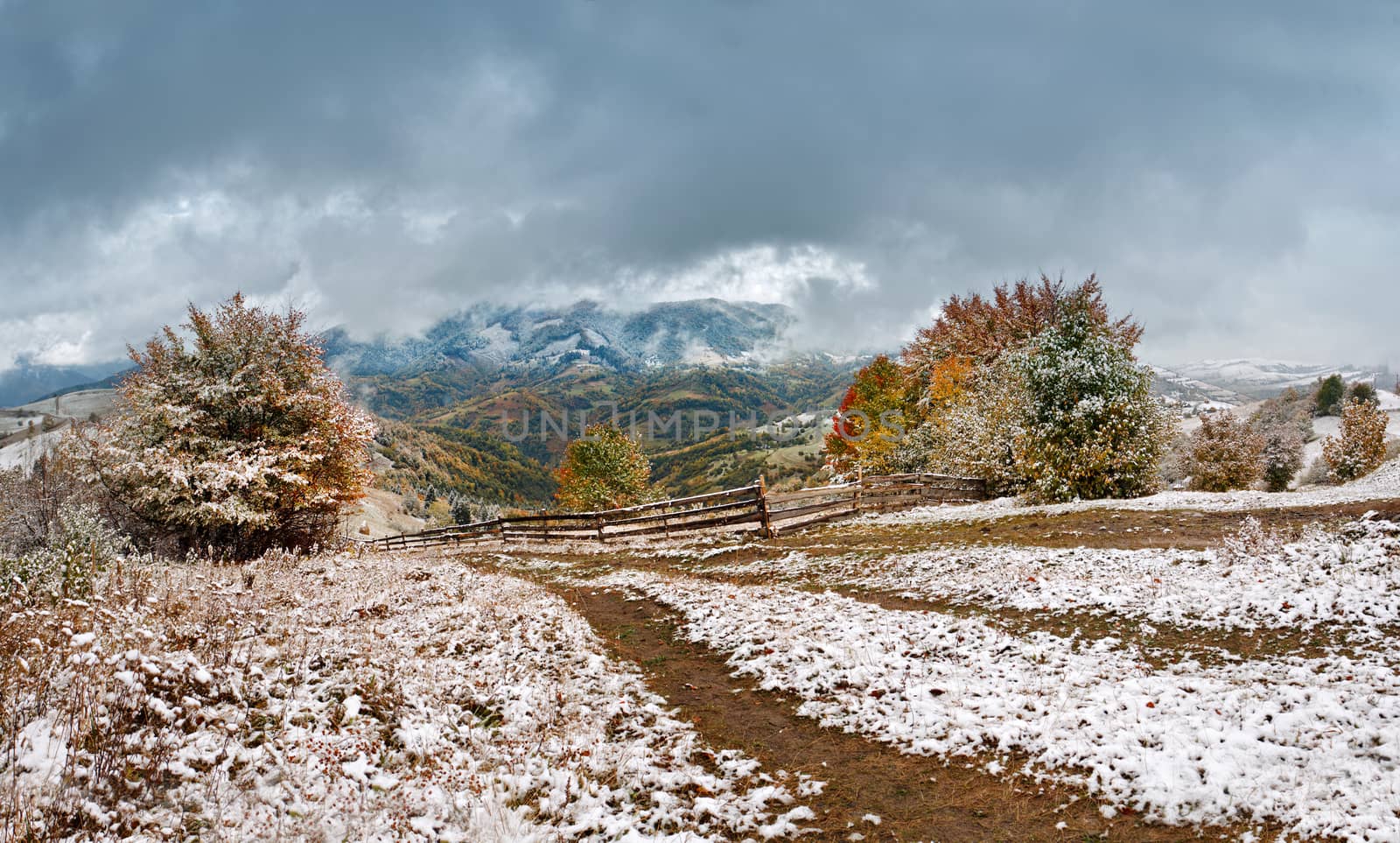 First snow in autumn. Snowfall in mountain village by weise_maxim