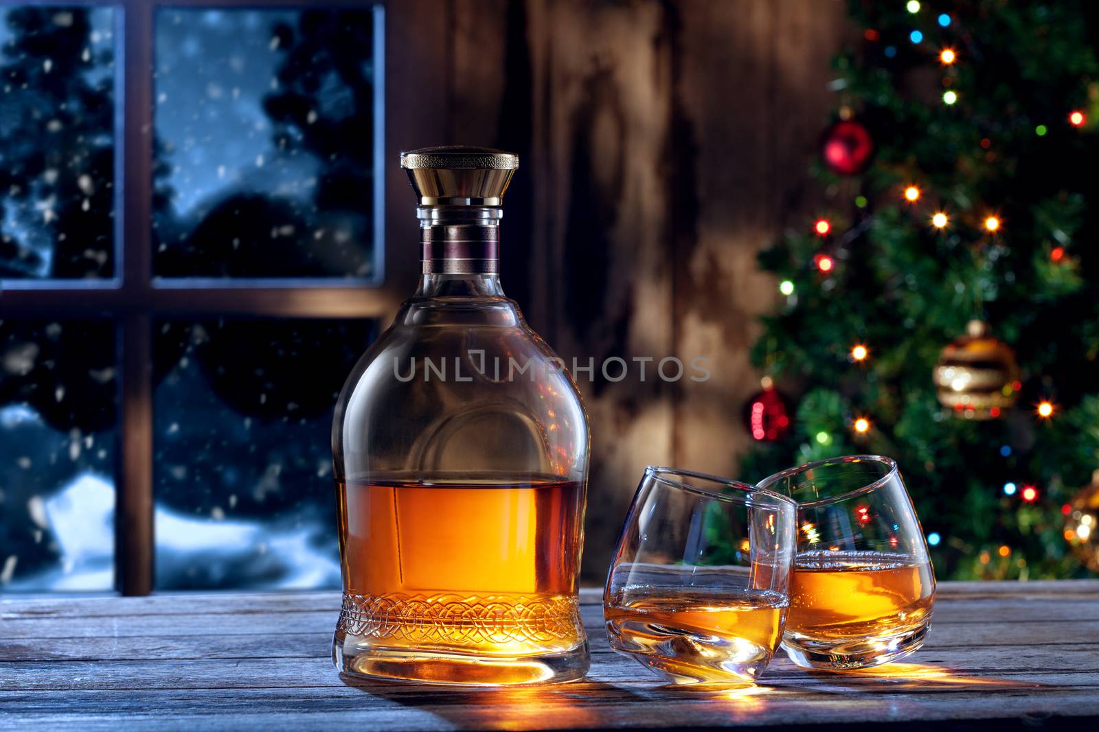 close up view  of two glasses with whiskey on color back