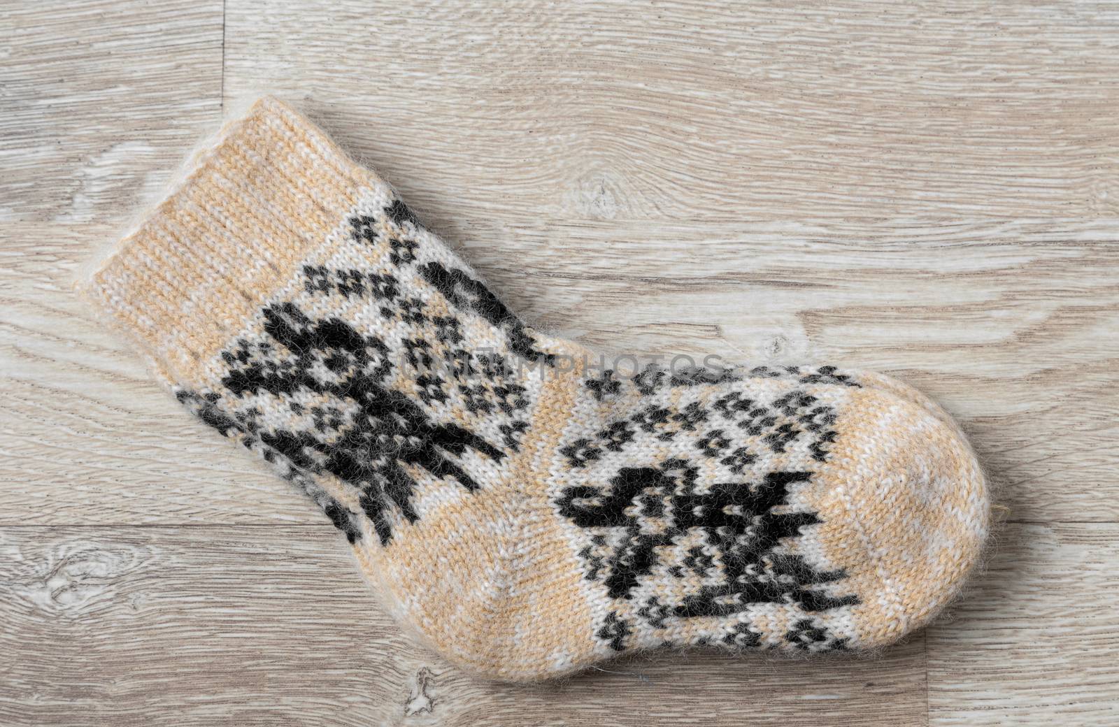 Pair of wool socks against wood background