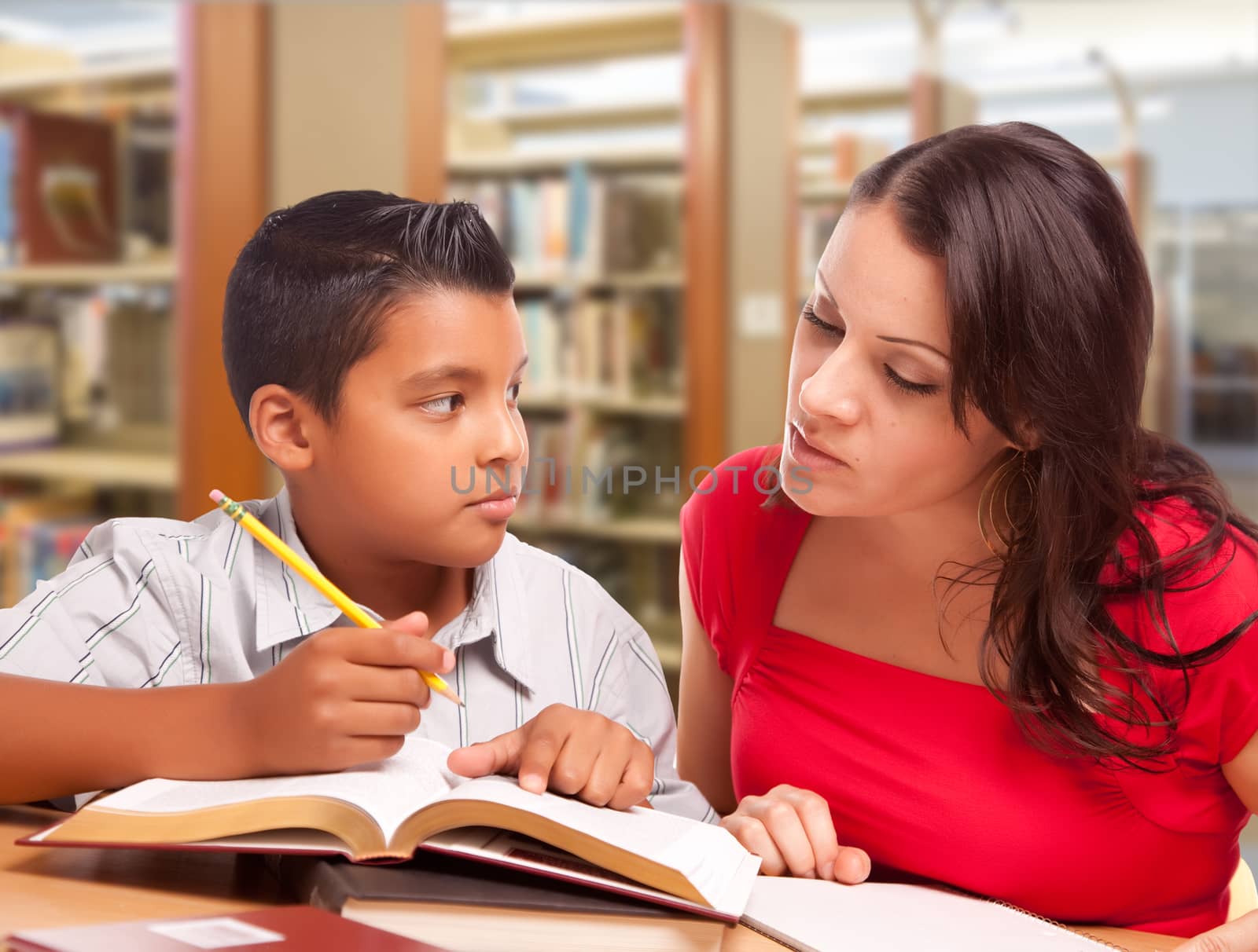 Hispanic Mother and Son Studying Inside The Library.