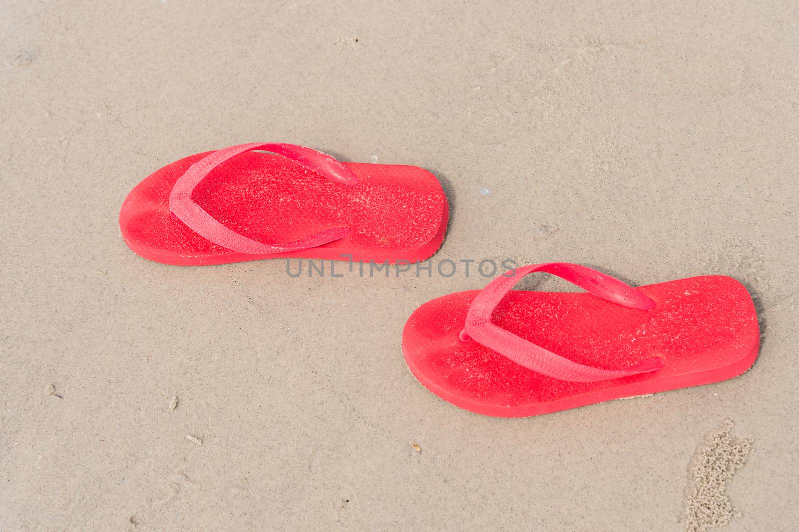 red sandals on beach by luckyfim