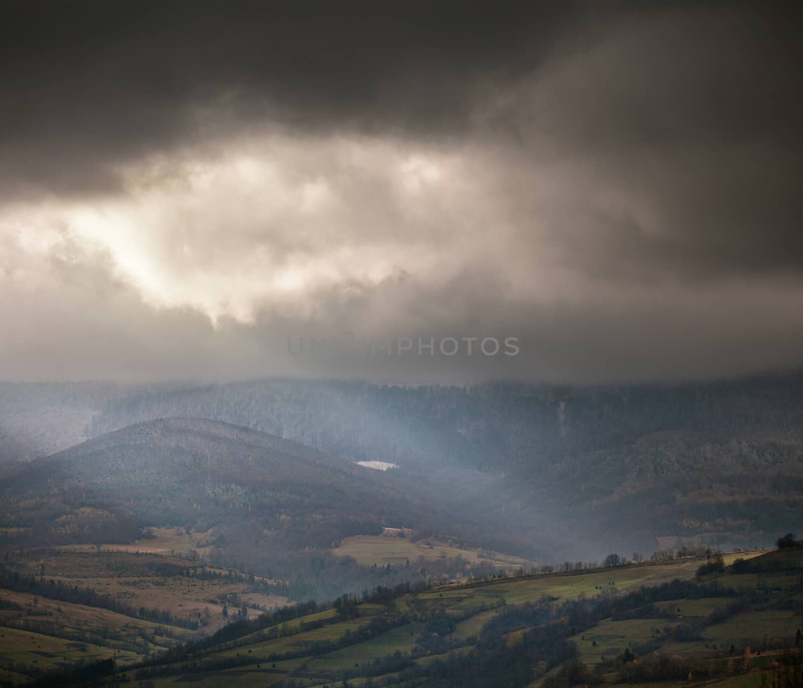 Overcast scene in cloudy mountains. November rain