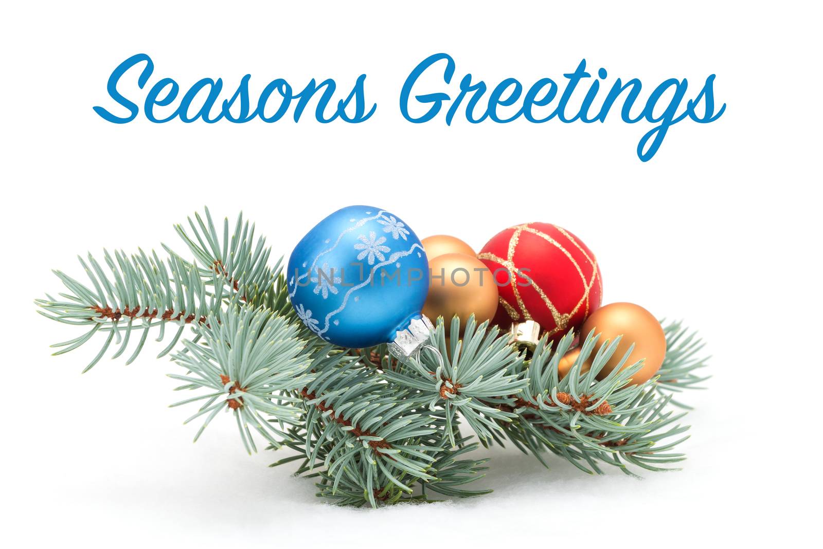 Colorful christmas baubles on a fresh spruce bough.