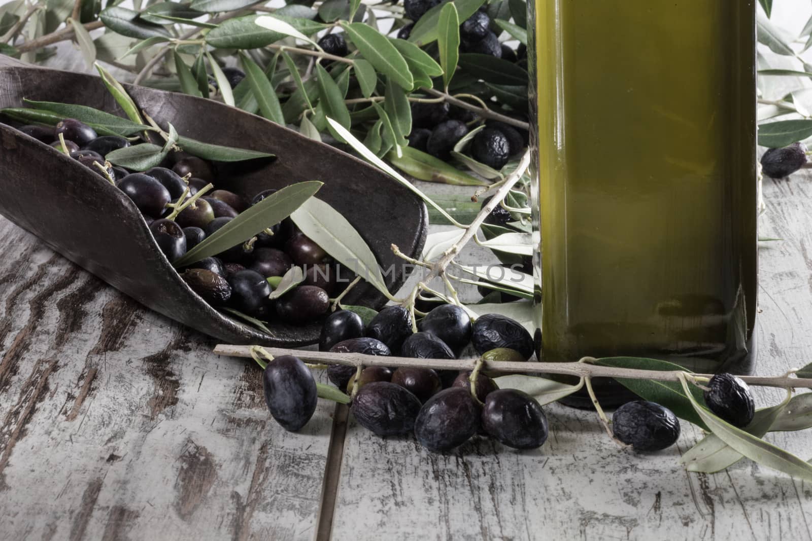 Olive oil and Olive on wood