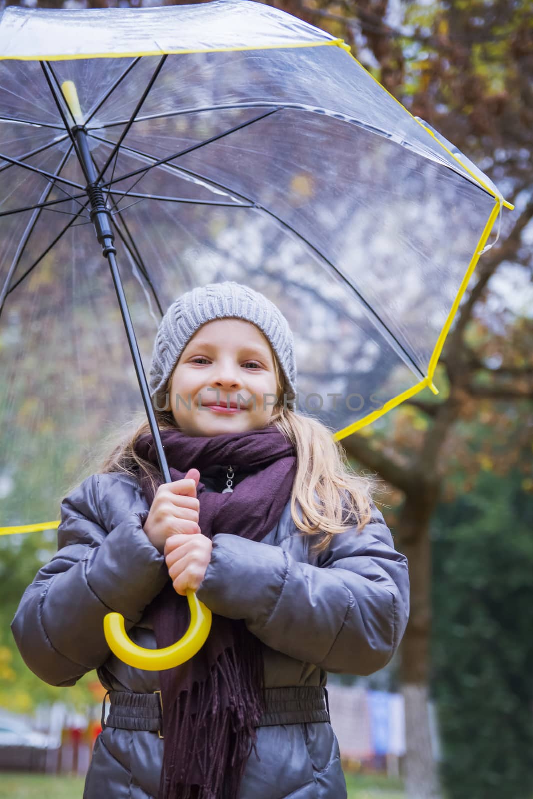 Happy girl with umbrella in autumn