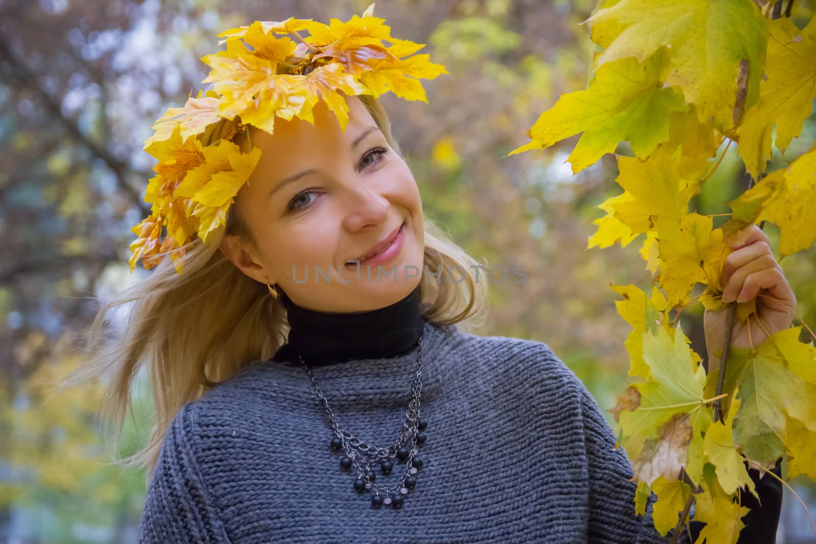 Autumn woman with crown of yellow maple leaves