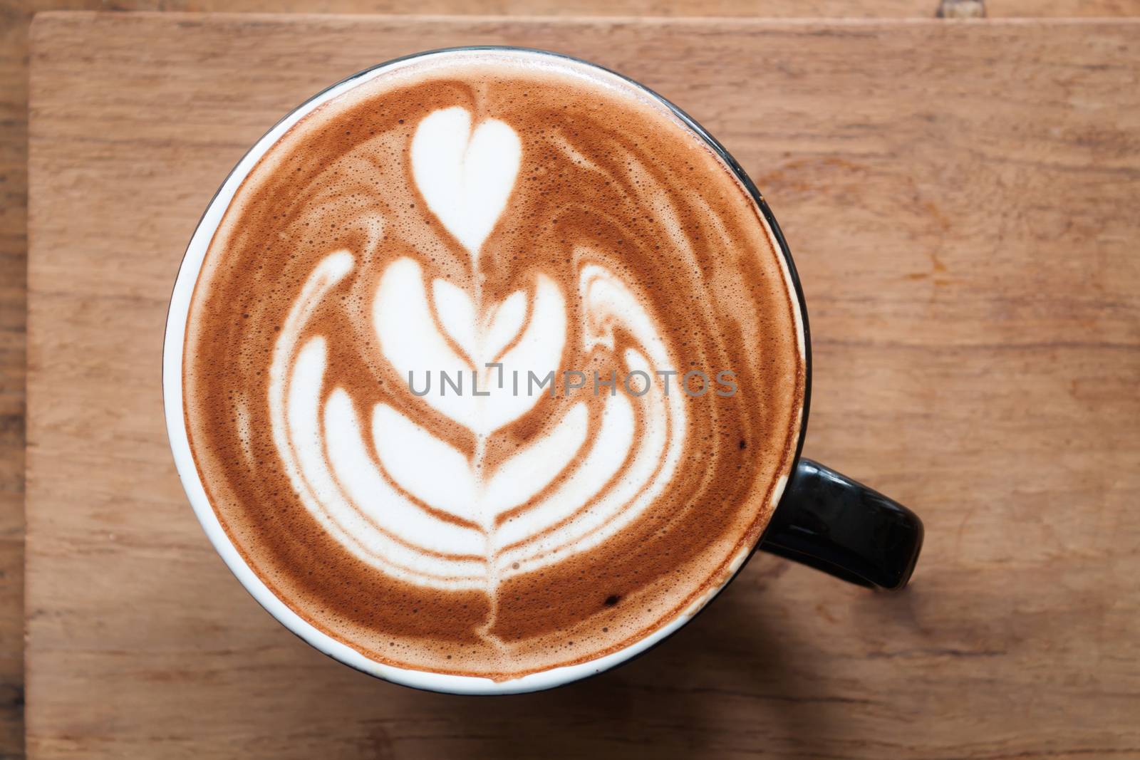 Top view of hot coffee on wooden table by punsayaporn