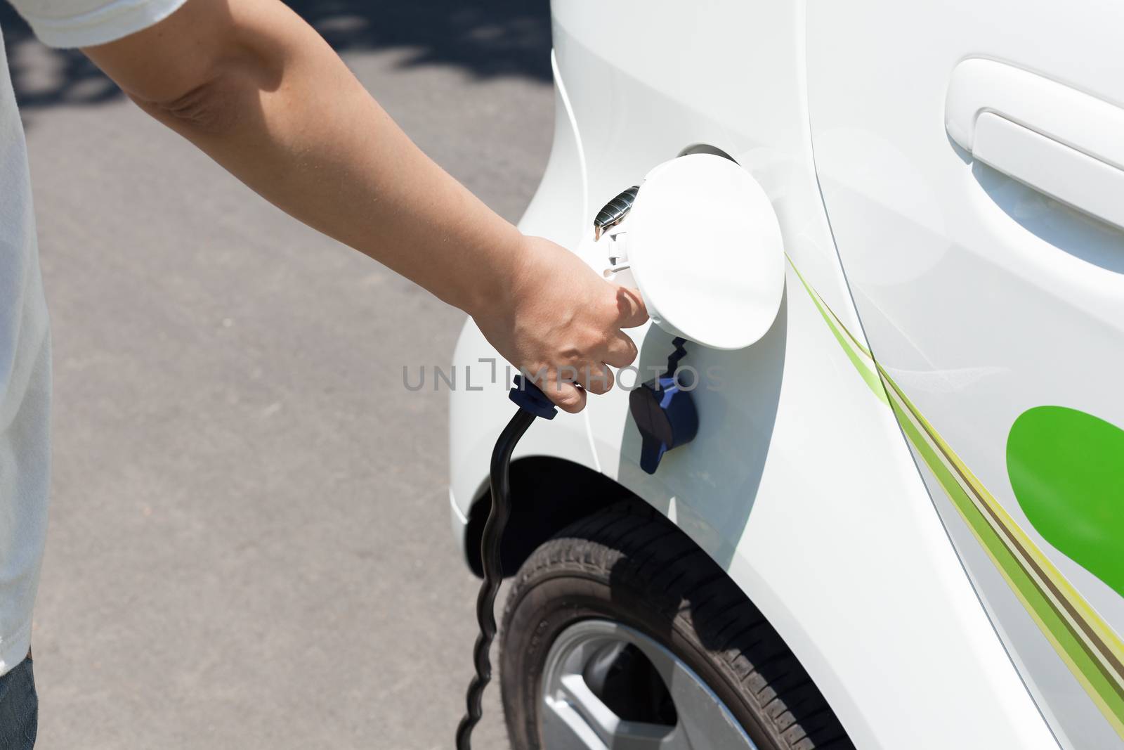 Electric car charging by wellphoto