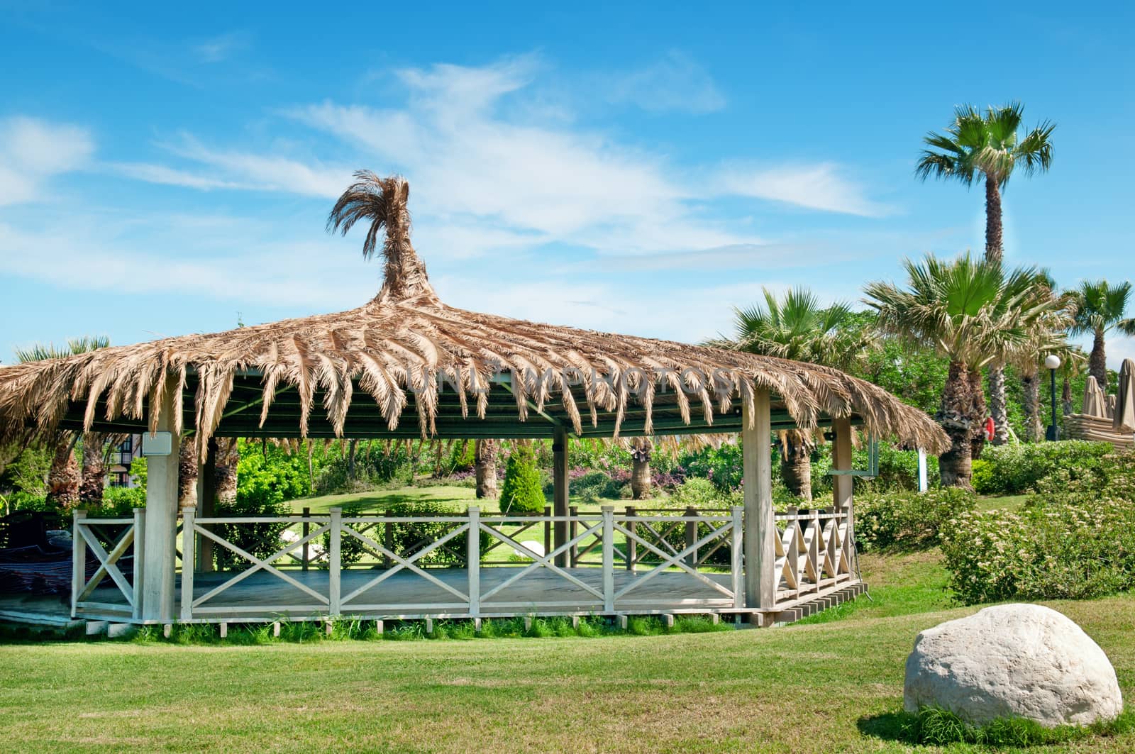 outdoor pavilion, lawn and palm trees