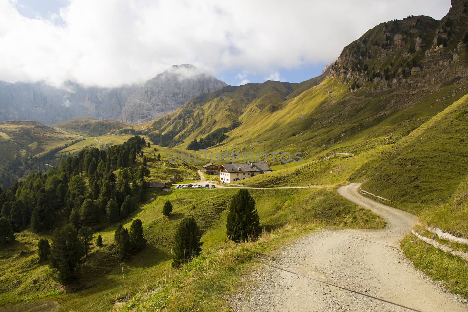 View of a hiking trail on Seiser Alm and a refuge  on the background