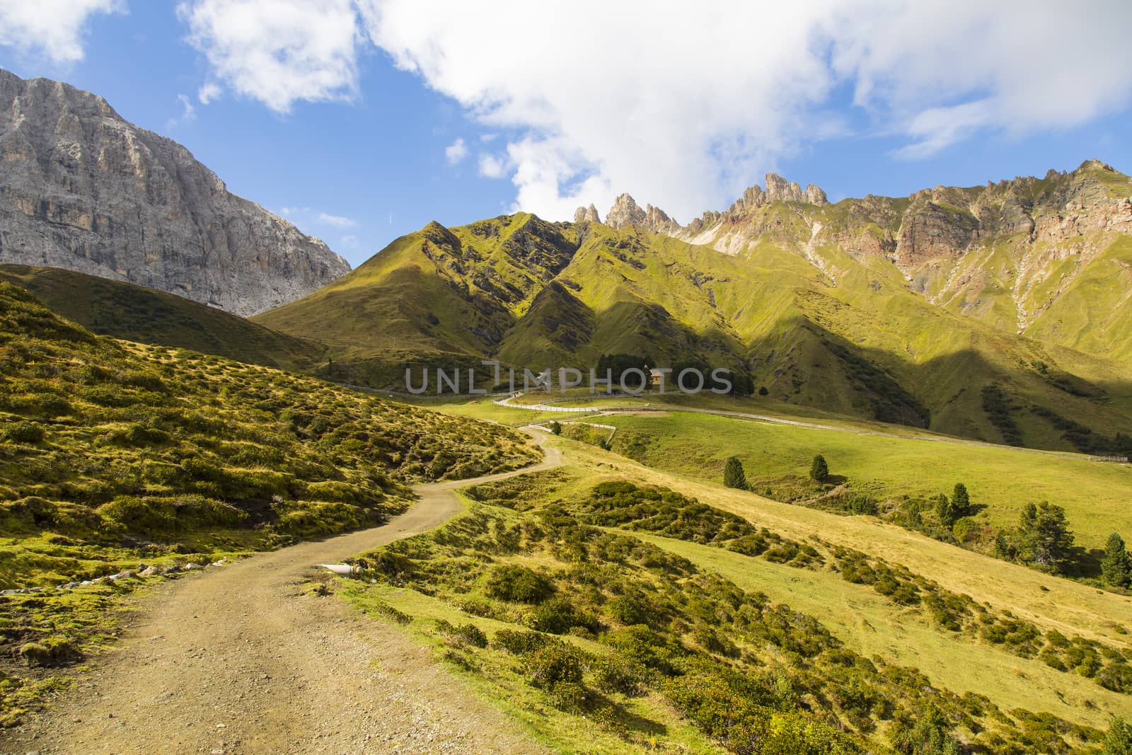 View of a hiking trail on Seiser Alm with mountain range on the background