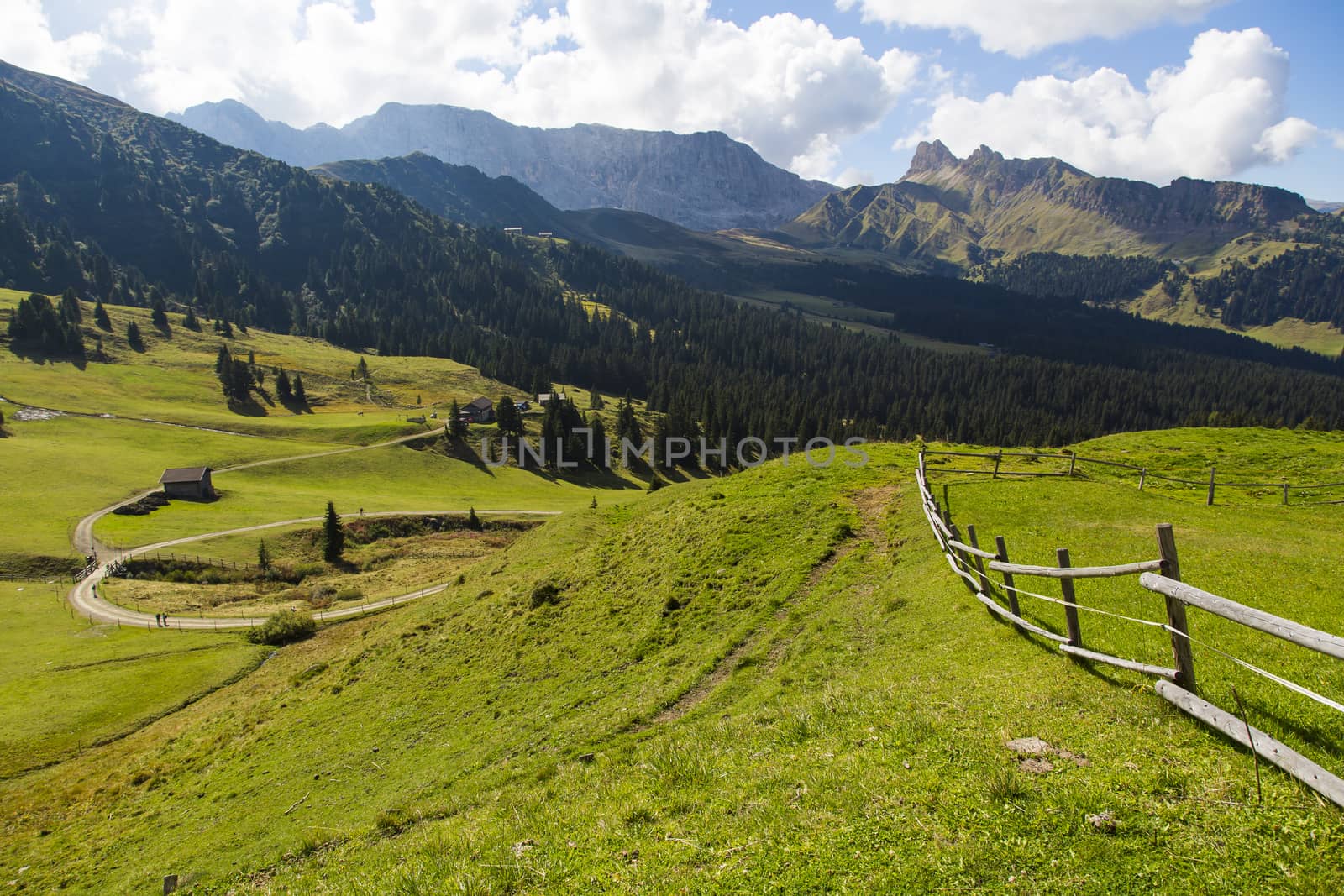 Mountain landscape with wooden fence, shelter and hiking trails