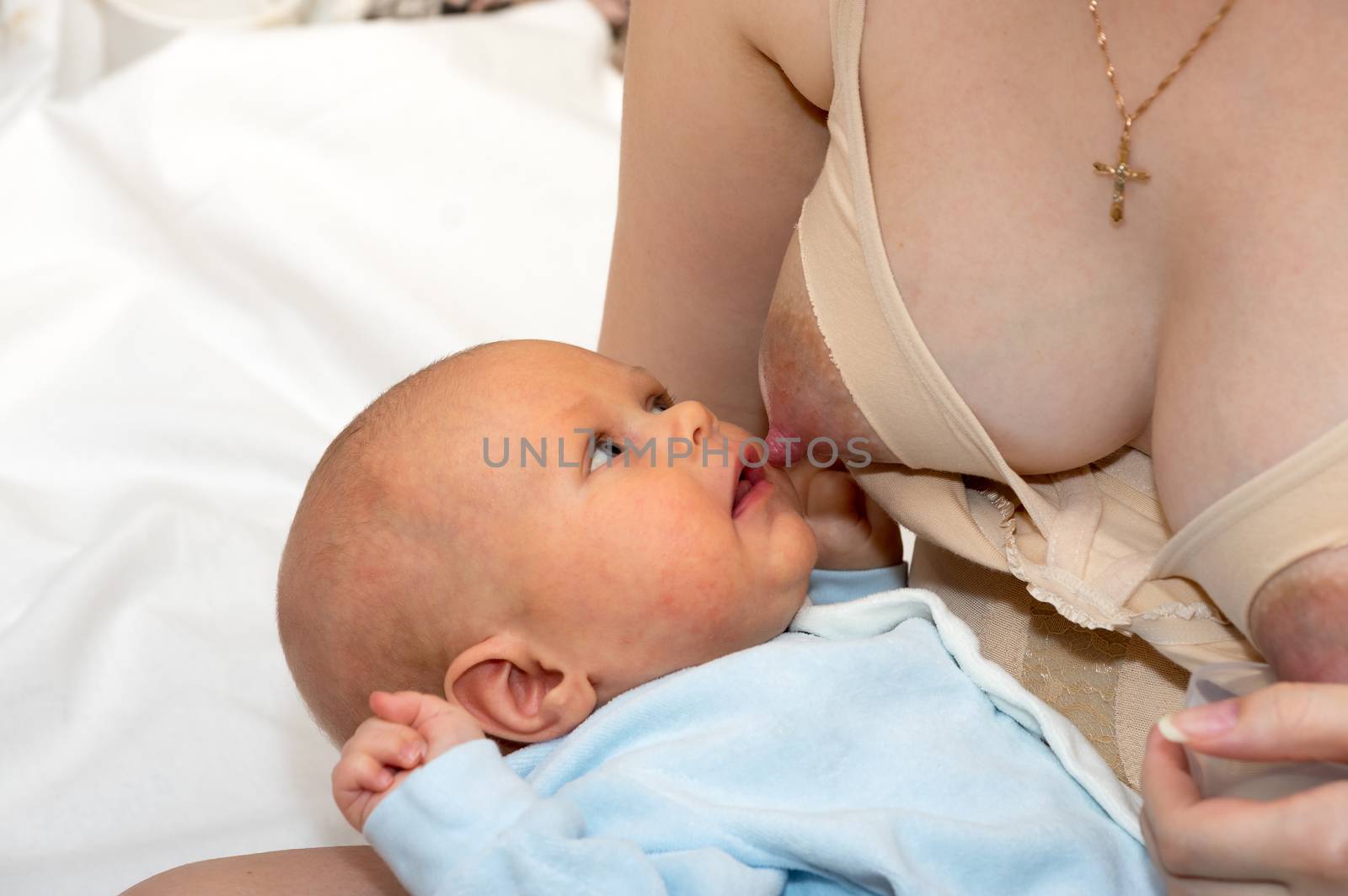 Mother breastfeeds the baby close up shot