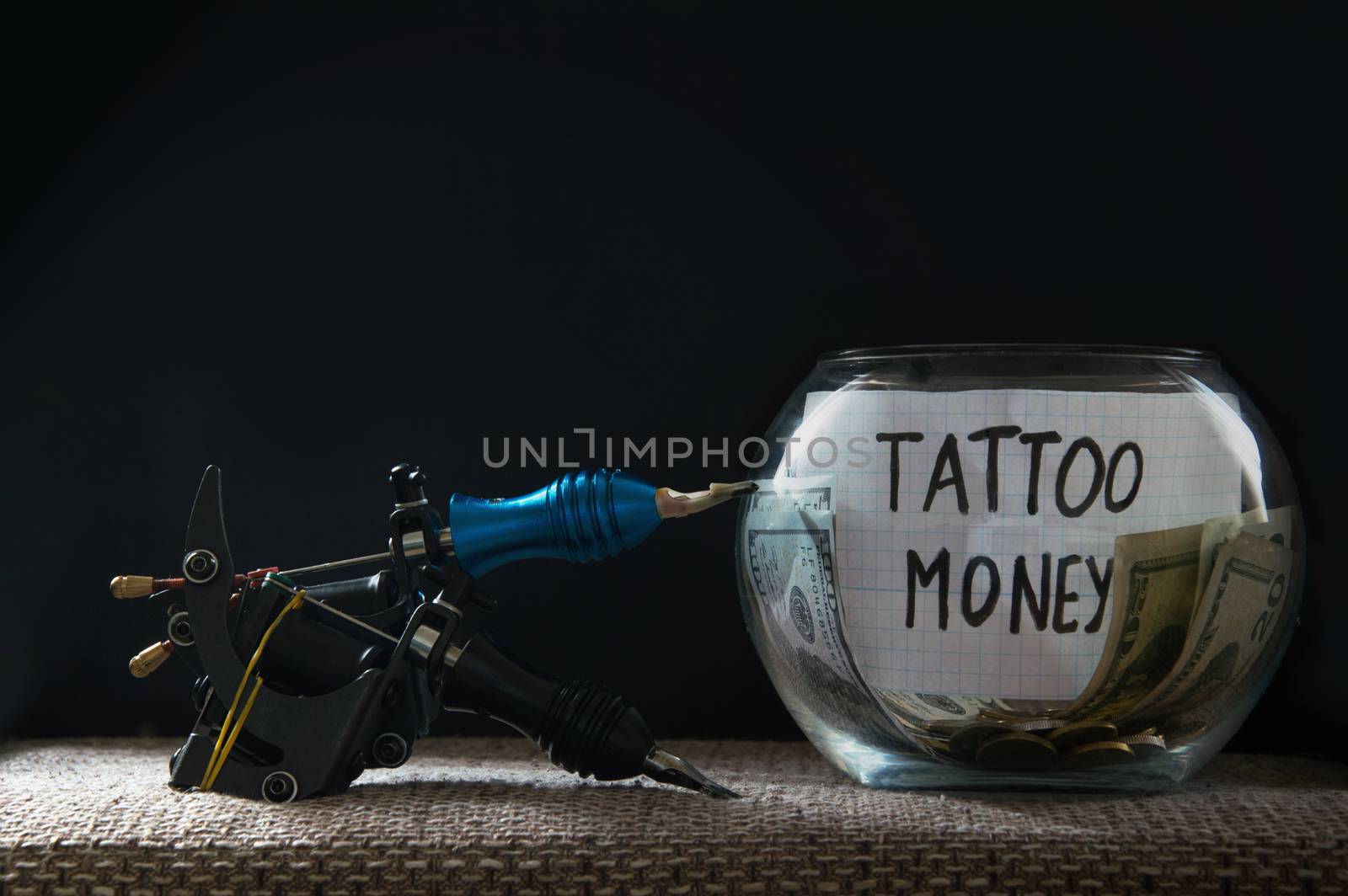 Glass jar witn money for tattoo and tattoo machines