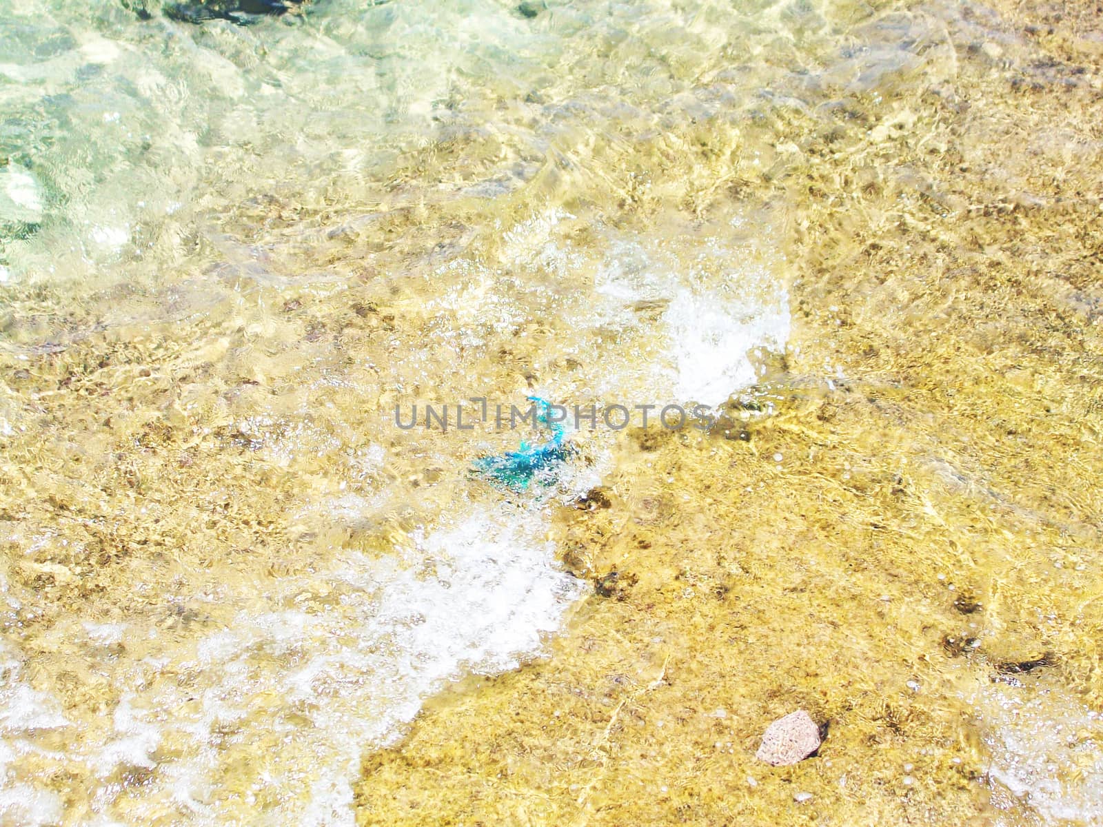Сlear transparent water in the shallows of the coastal beach