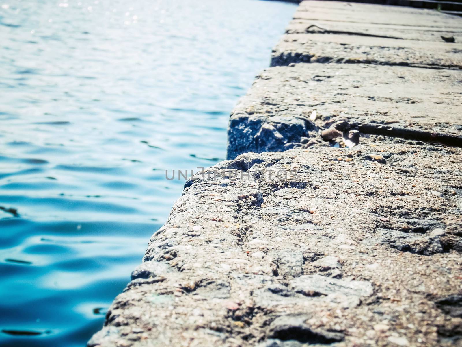 Phoro of stone slabs near the water in focus